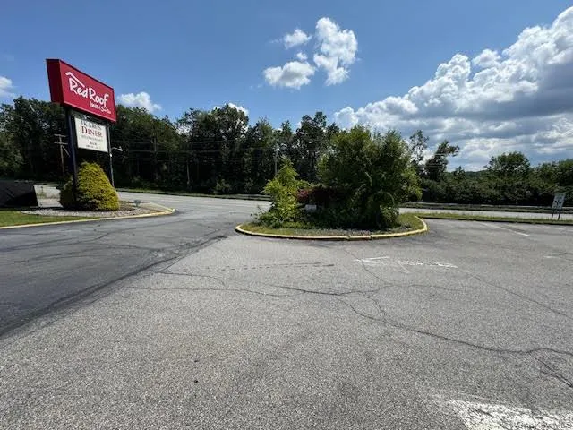 View of asphalt road featuring curbs View of asphalt road featuring curbs