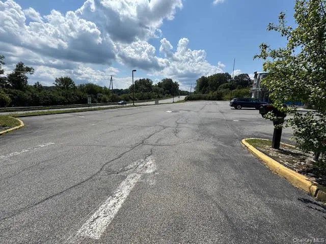 View of asphalt street with street lights and curbs View of asphalt street with street lights and curbs