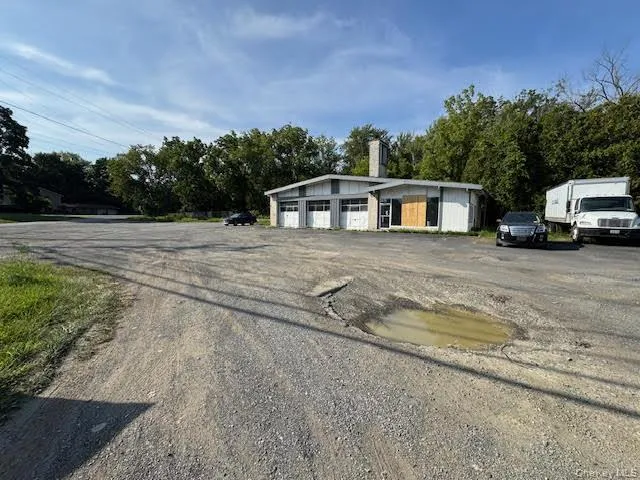 View of front of property featuring a garage and an outdoor structure View of front of property featuring a garage and an outdoor structure