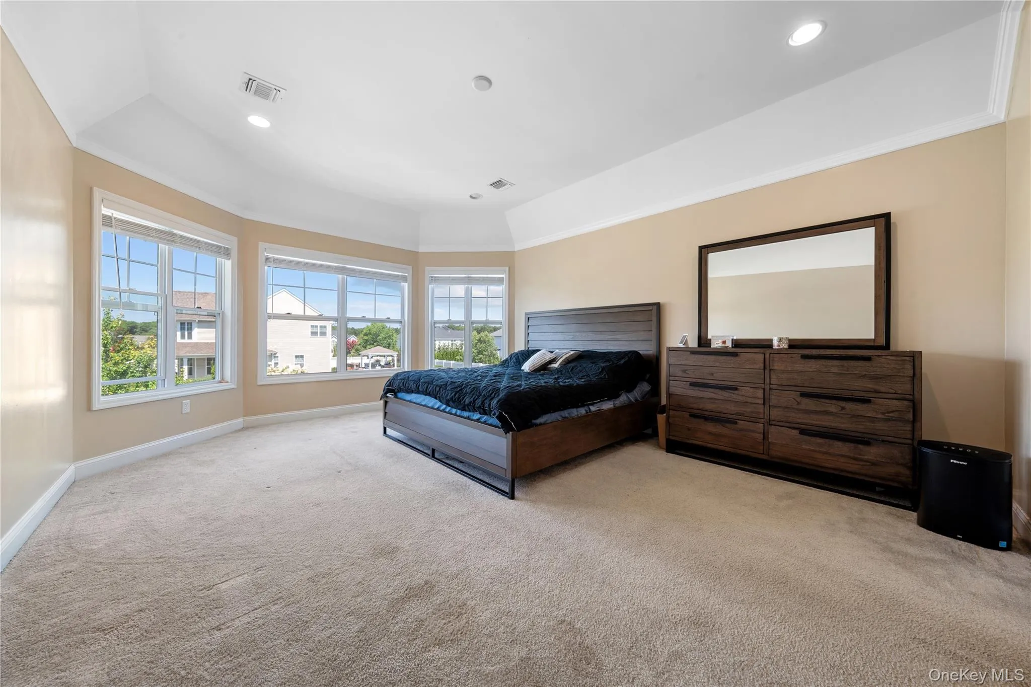 Bedroom featuring light carpet, crown molding, and recessed lighting Bedroom featuring light carpet, crown molding, and recessed lighting