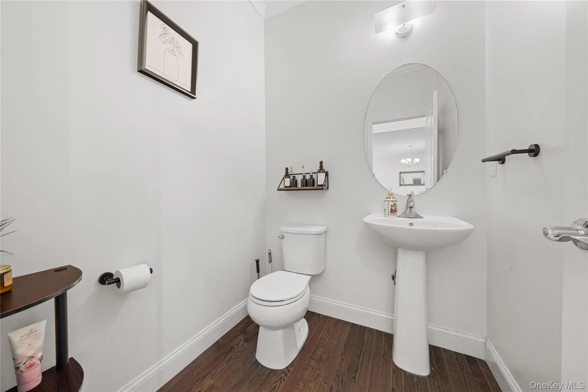 Bathroom featuring dark wood finished floors and ornamental molding Bathroom featuring dark wood finished floors and ornamental molding