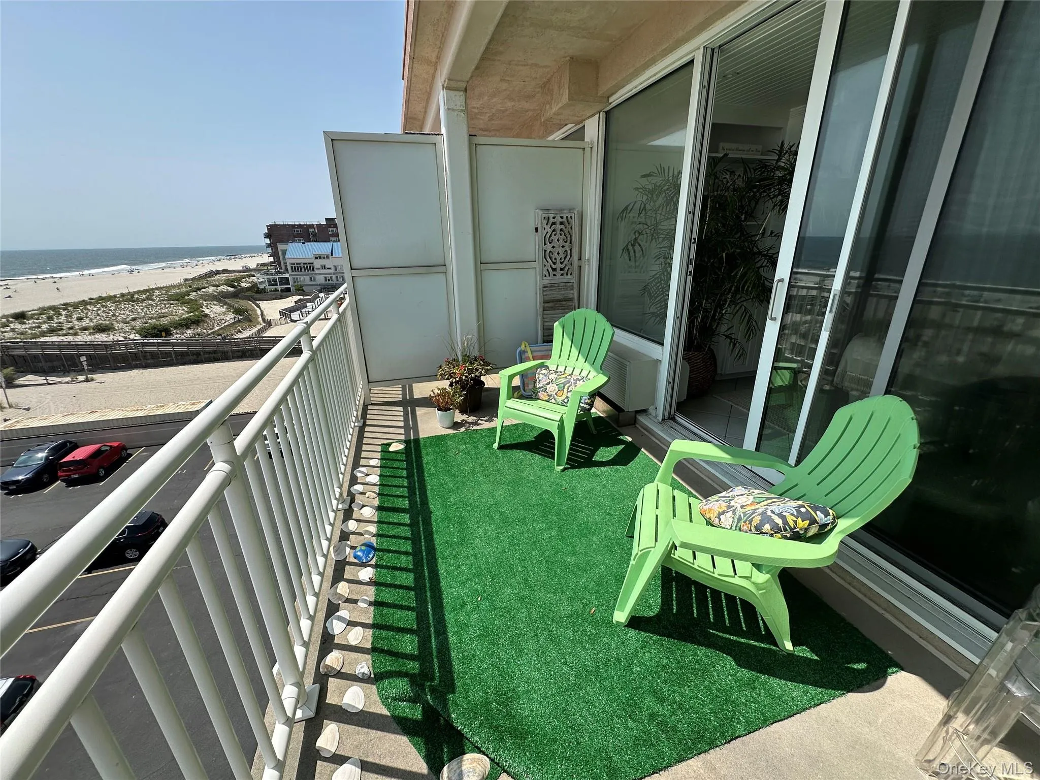 Balcony featuring view of water and beach Balcony featuring view of water and beach