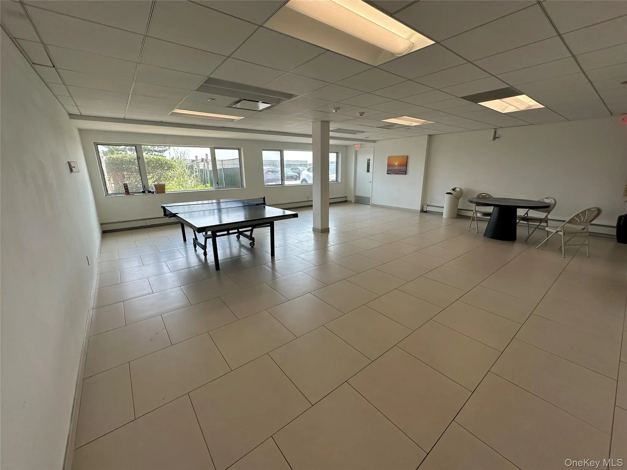 Rec room featuring a paneled ceiling and light tile patterned floors Rec room featuring a paneled ceiling and light tile patterned floors