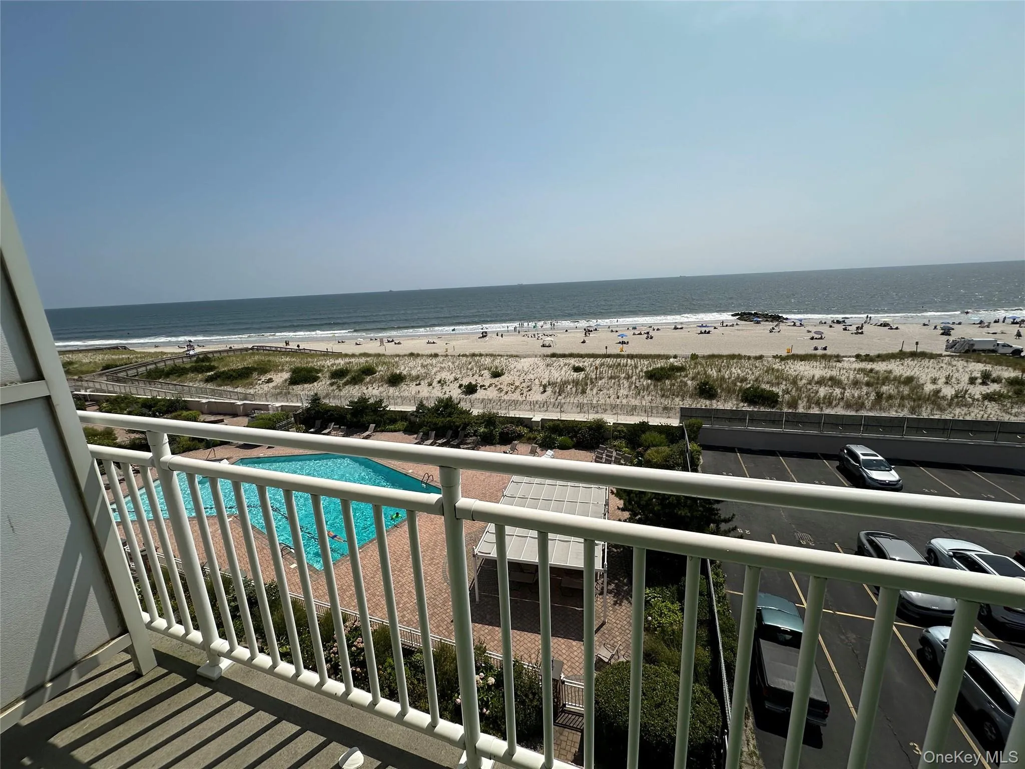 Balcony with view of pool area and view of water and beach Balcony with view of pool area and view of water and beach