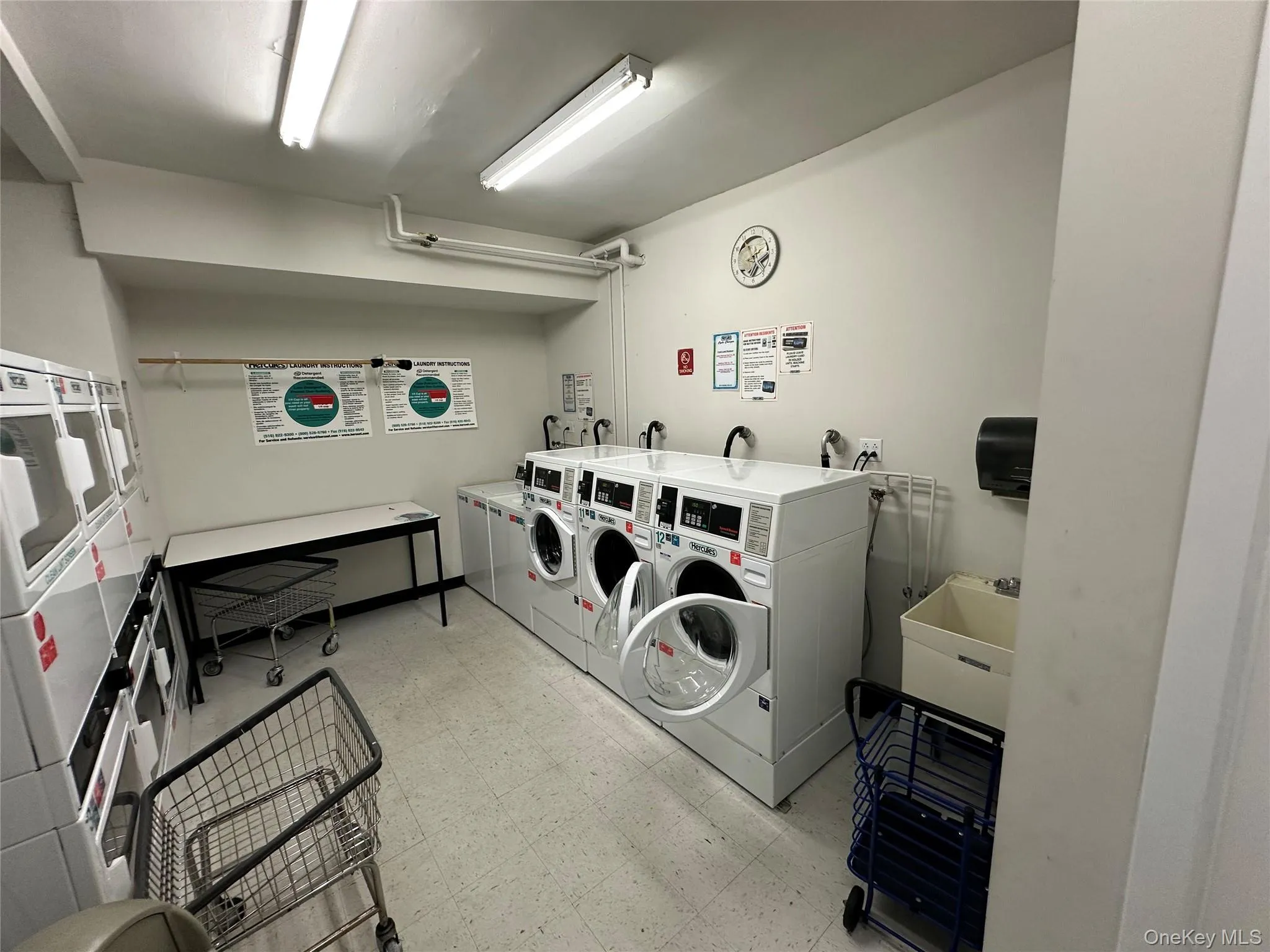 Laundry room featuring light floors and washing machine and dryer Laundry room featuring light floors and washing machine and dryer