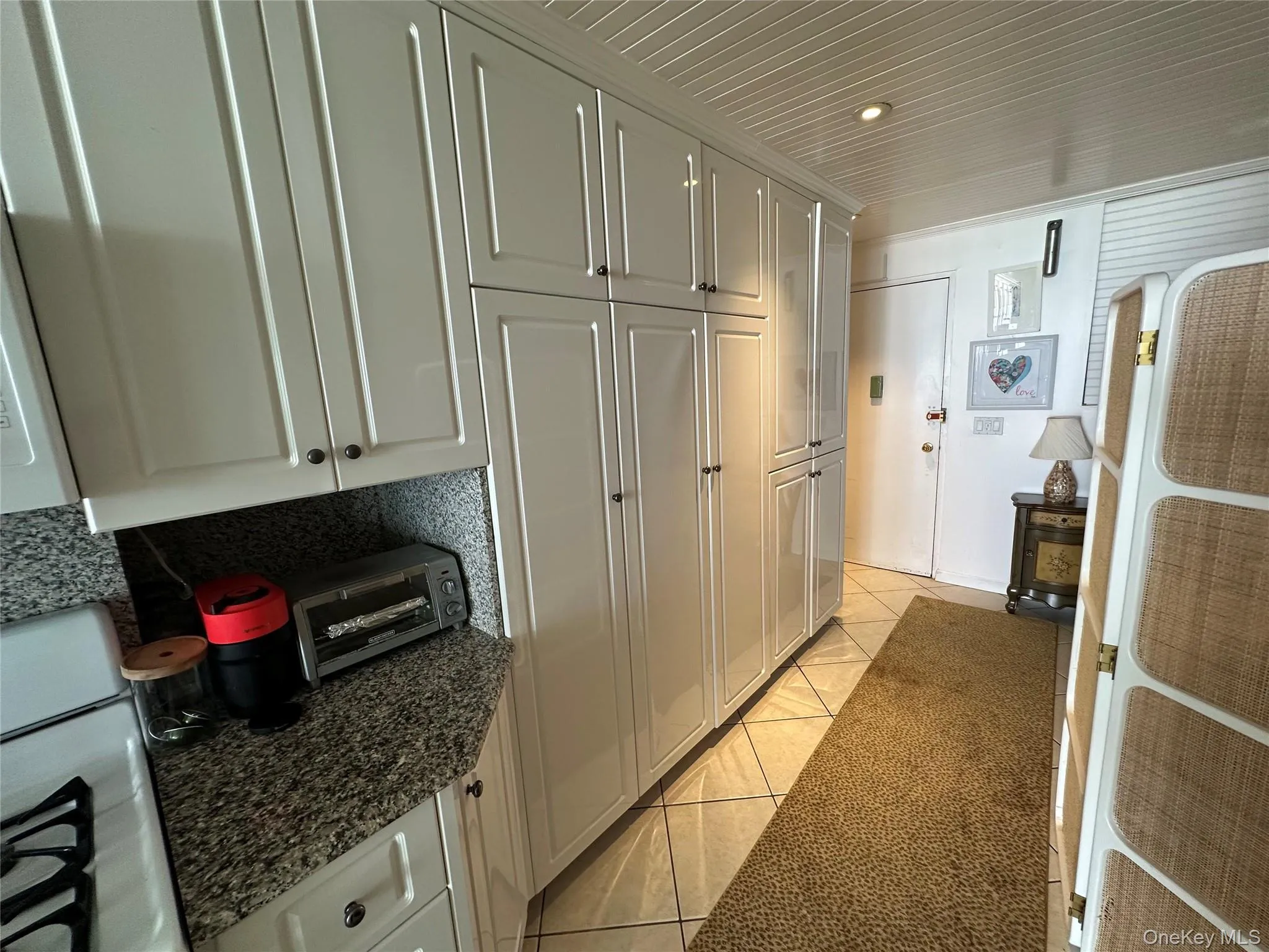 Kitchen with light tile patterned floors and dark stone counters Kitchen with light tile patterned floors and dark stone counters