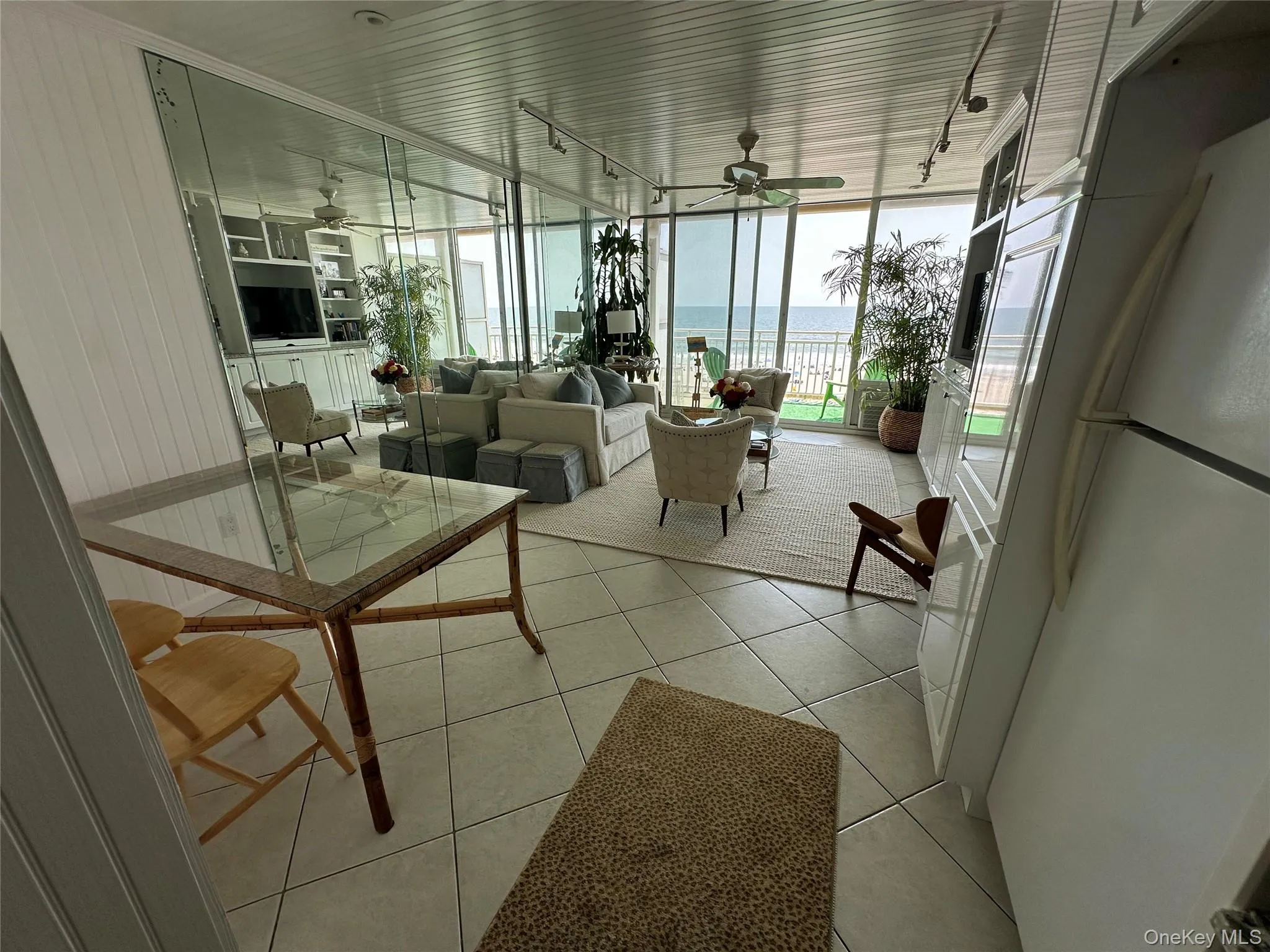 Community lobby with a wall of windows and wood walls Community lobby with a wall of windows and wood walls