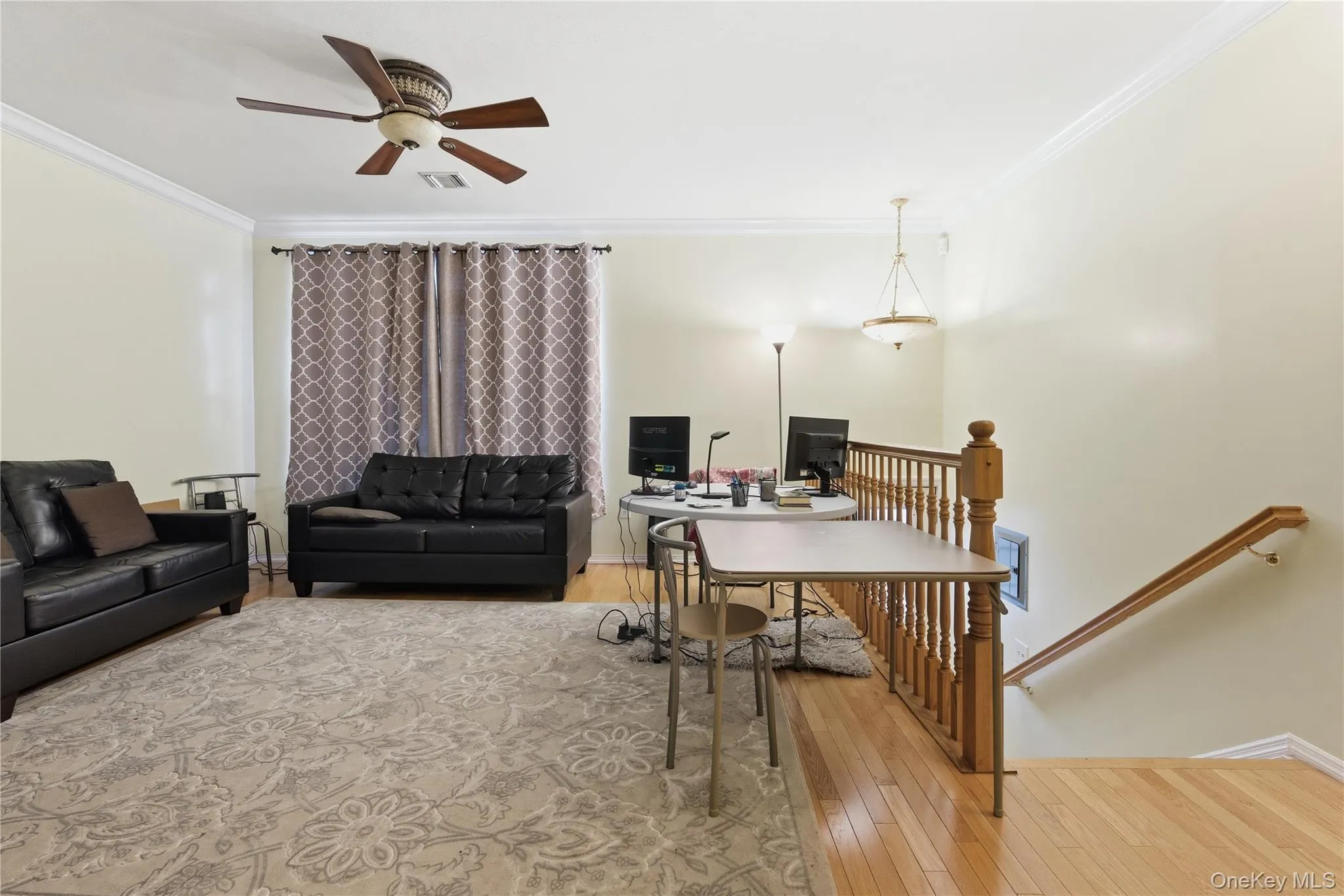 Home office featuring light wood finished floors, ornamental molding, and ceiling fan Home office featuring light wood finished floors, ornamental molding, and ceiling fan