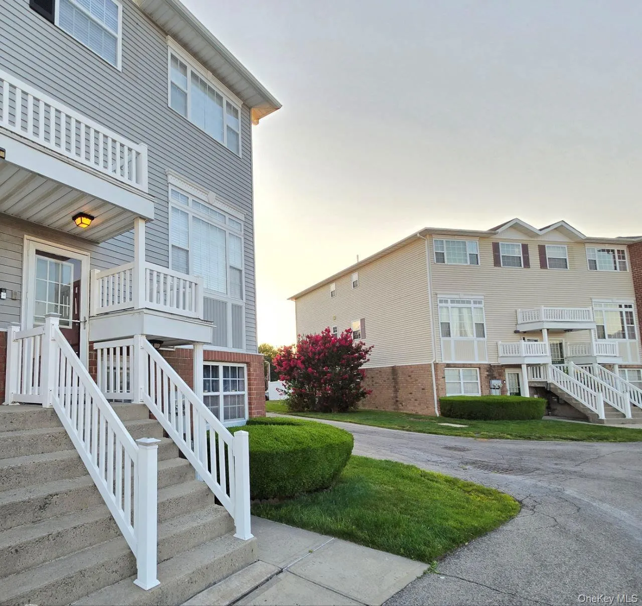 View of property exterior with brick siding and stairway View of property exterior with brick siding and stairway