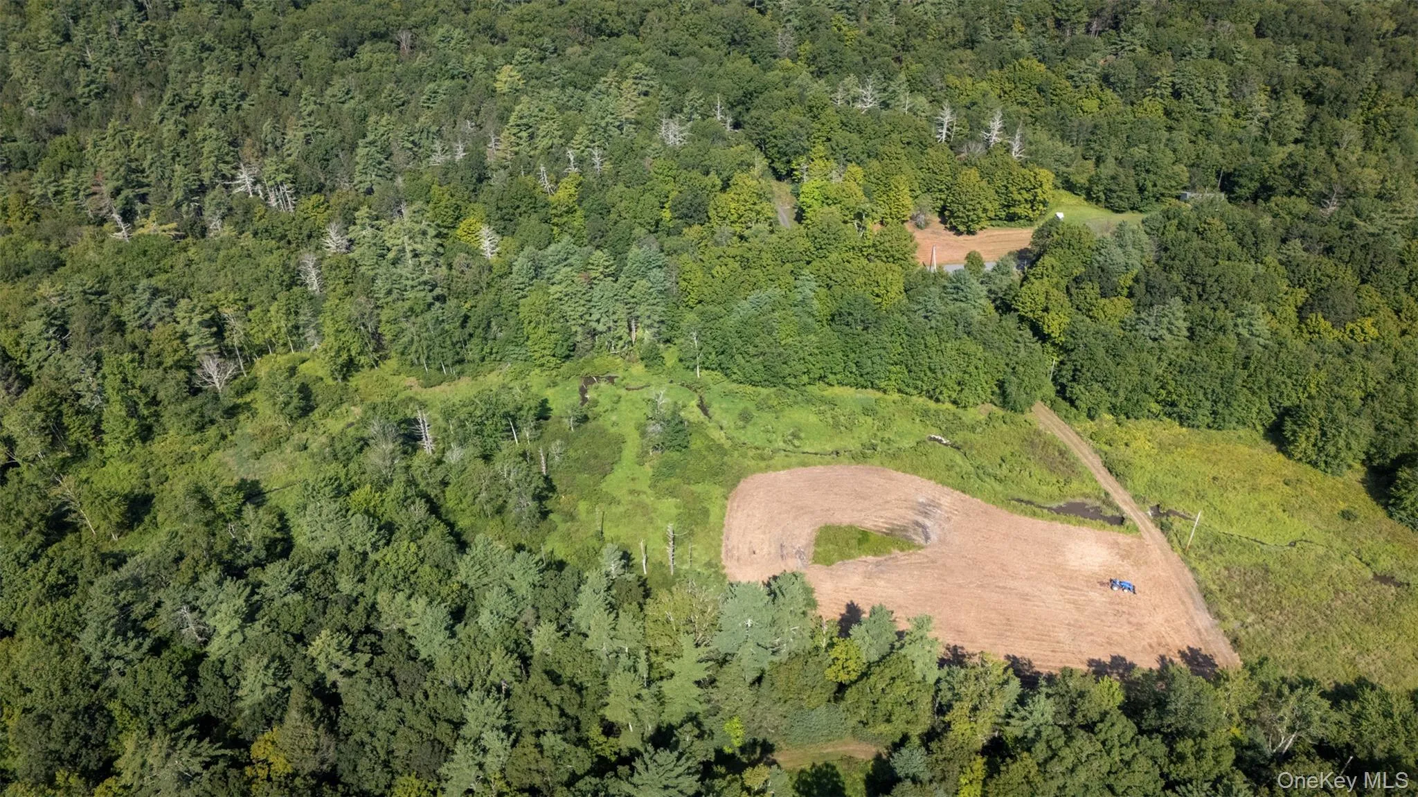 Aerial overview of property's location with a heavily wooded area Aerial overview of property's location with a heavily wooded area