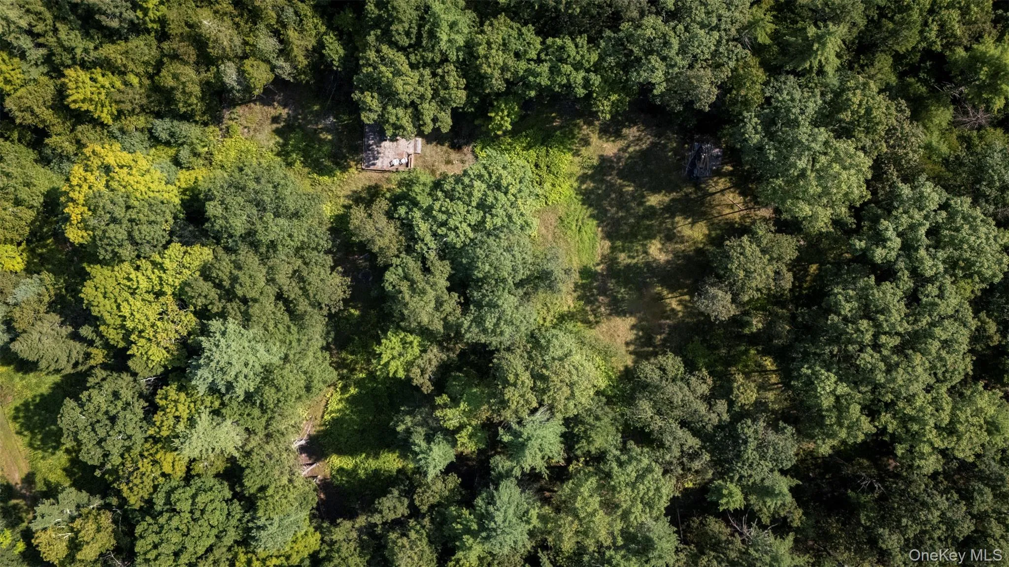 View of property location with a heavily wooded area View of property location with a heavily wooded area