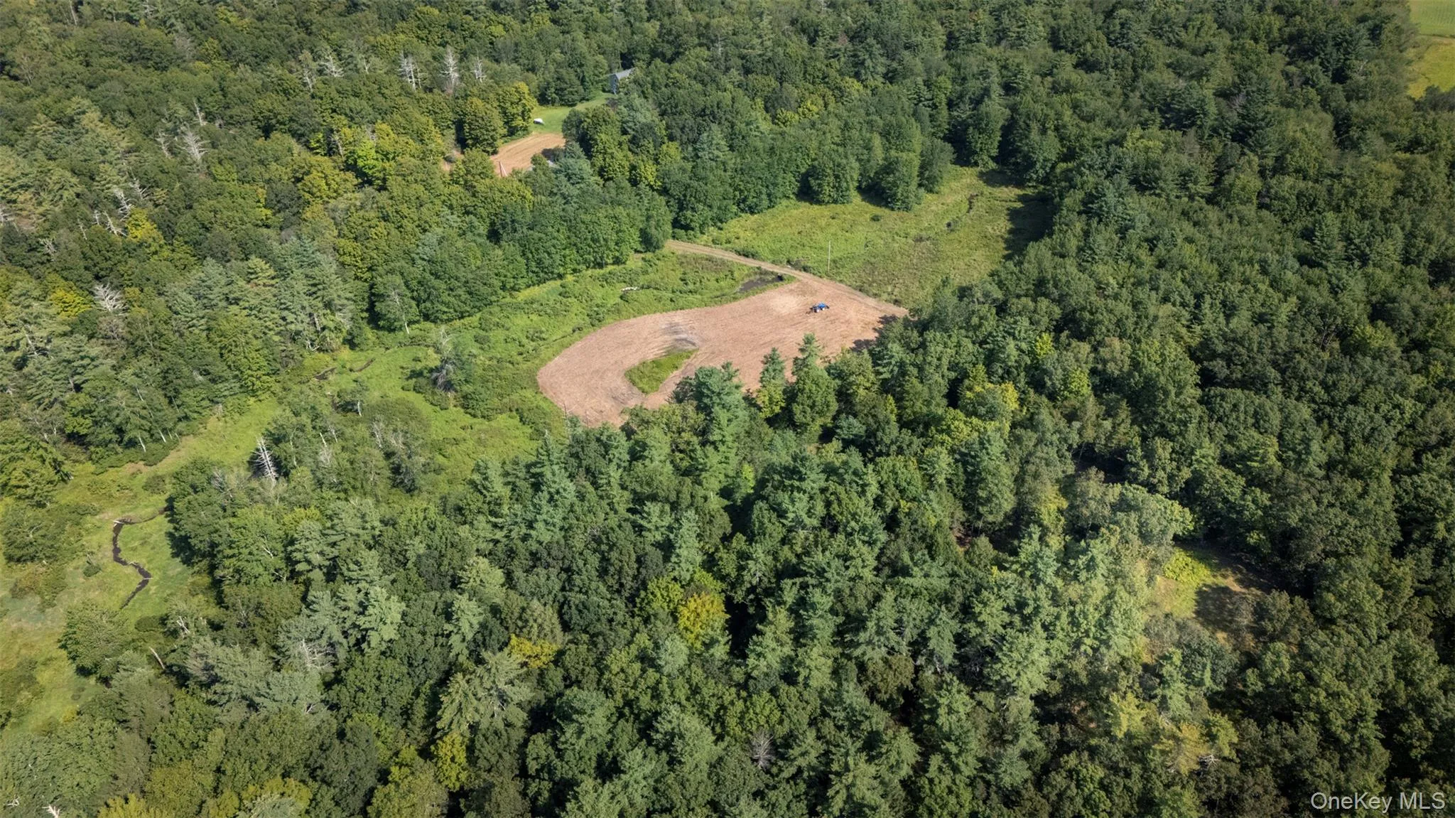 Aerial view of property's location featuring a heavily wooded area Aerial view of property's location featuring a heavily wooded area