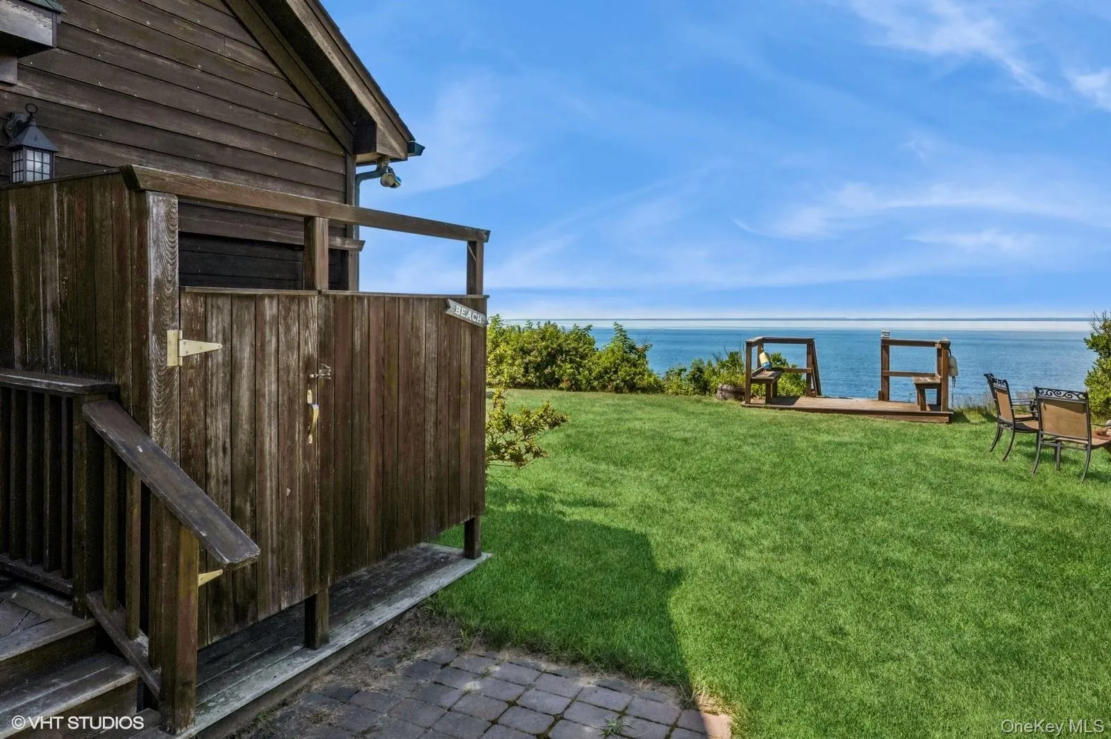 View of green lawn with a water view View of green lawn with a water view