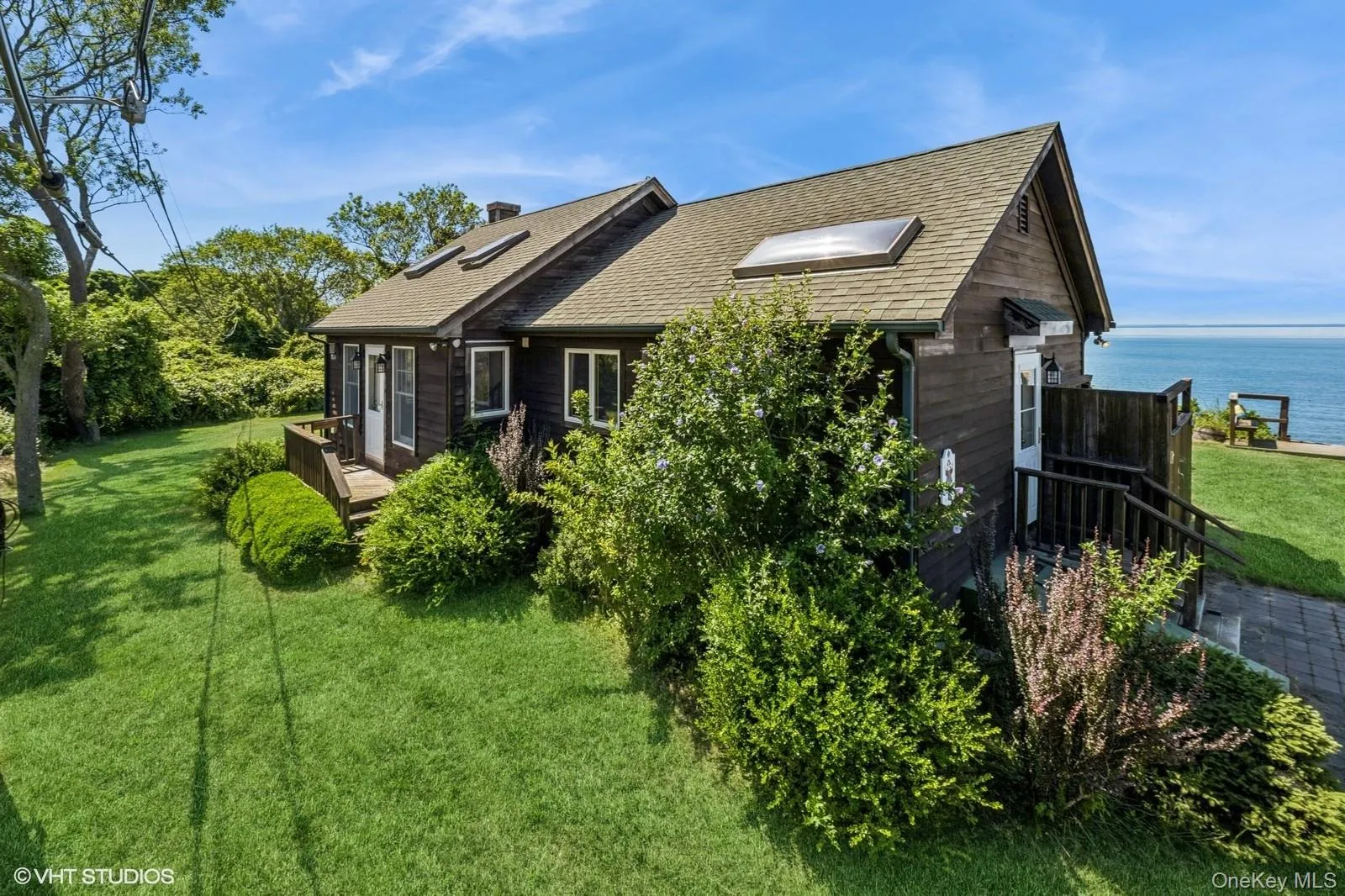 View of home's exterior with a yard, a shingled roof, and a chimney View of home's exterior with a yard, a shingled roof, and a chimney