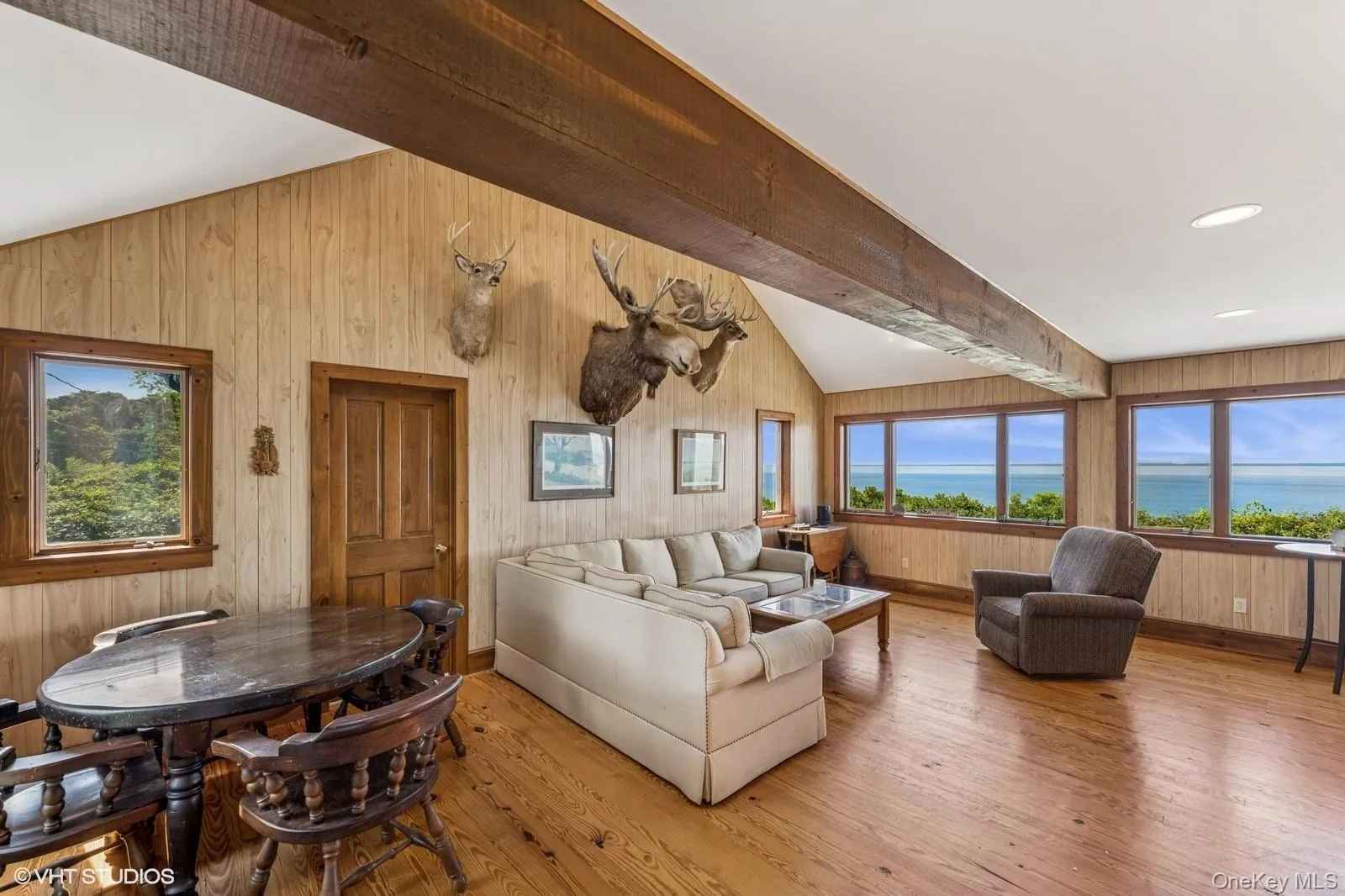 Living area featuring light wood-style flooring and wood walls Living area featuring light wood-style flooring and wood walls