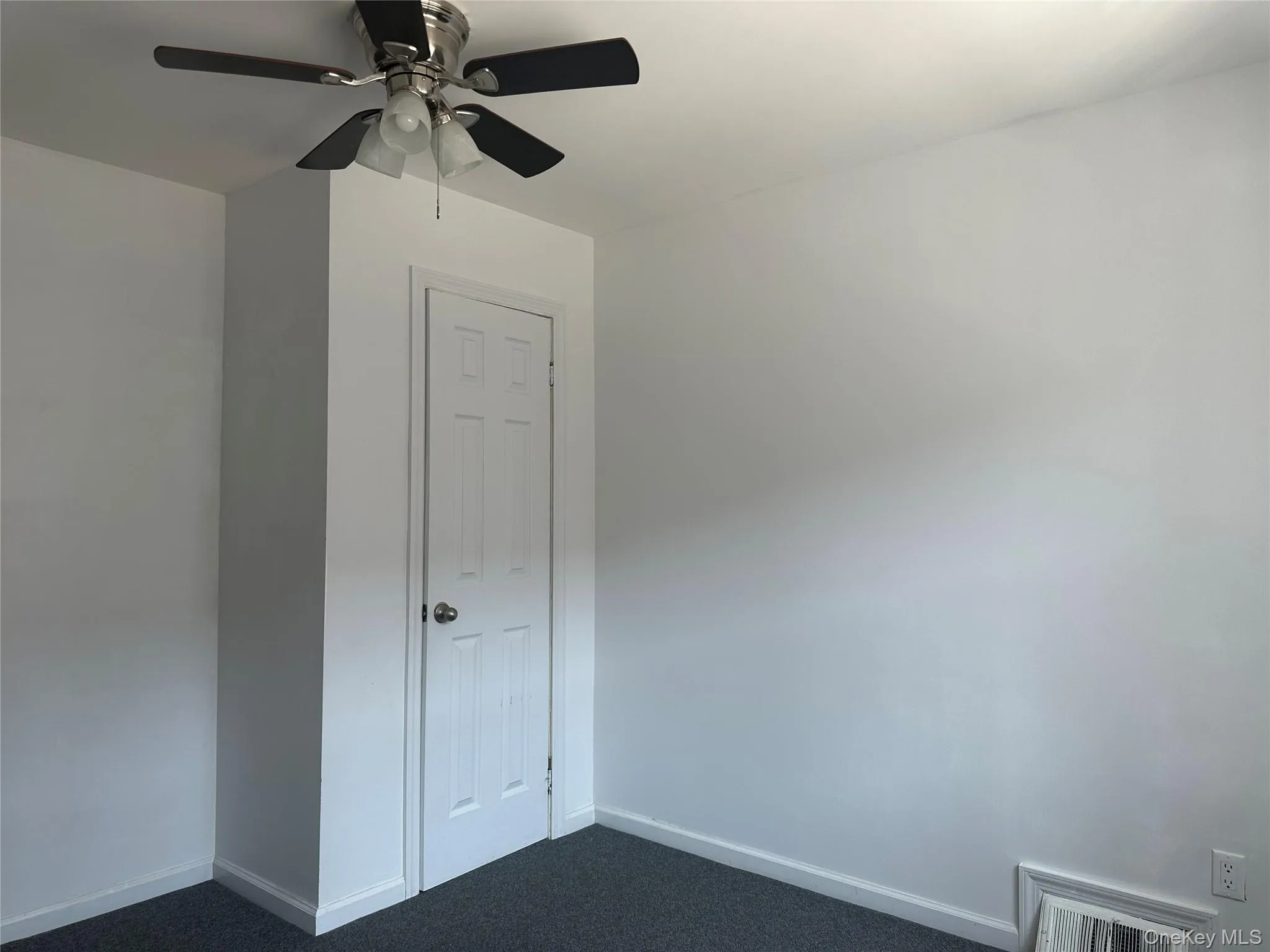Carpeted spare room featuring baseboards and a ceiling fan Carpeted spare room featuring baseboards and a ceiling fan