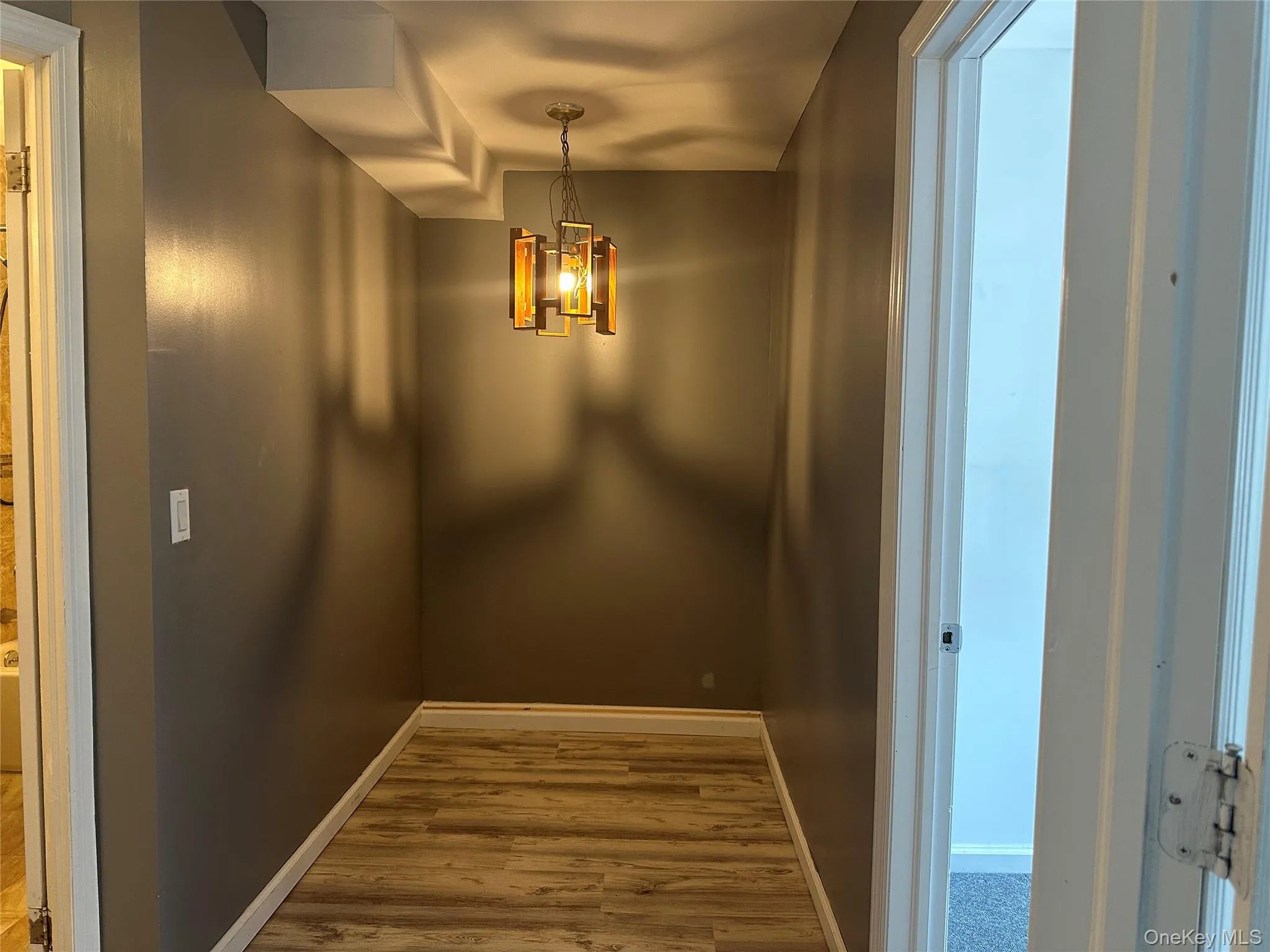 Detailed view of wood finished floors and a chandelier Detailed view of wood finished floors and a chandelier