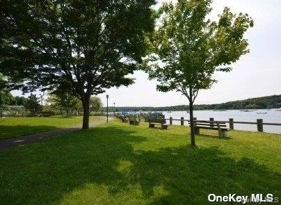 View of property's community with a yard and a water view View of property's community with a yard and a water view