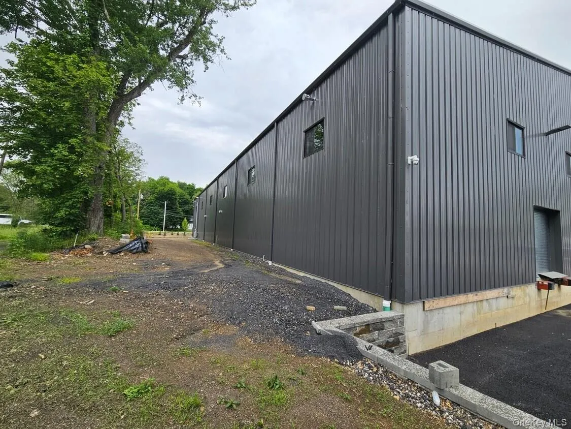 View of property exterior with an outbuilding and an outdoor structure View of property exterior with an outbuilding and an outdoor structure