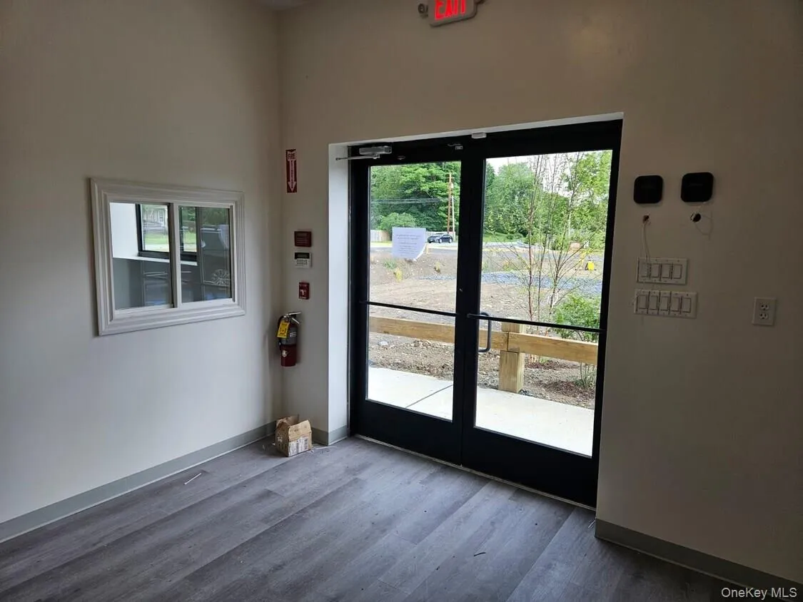Doorway to outside with wood finished floors and healthy amount of natural light Doorway to outside with wood finished floors and healthy amount of natural light