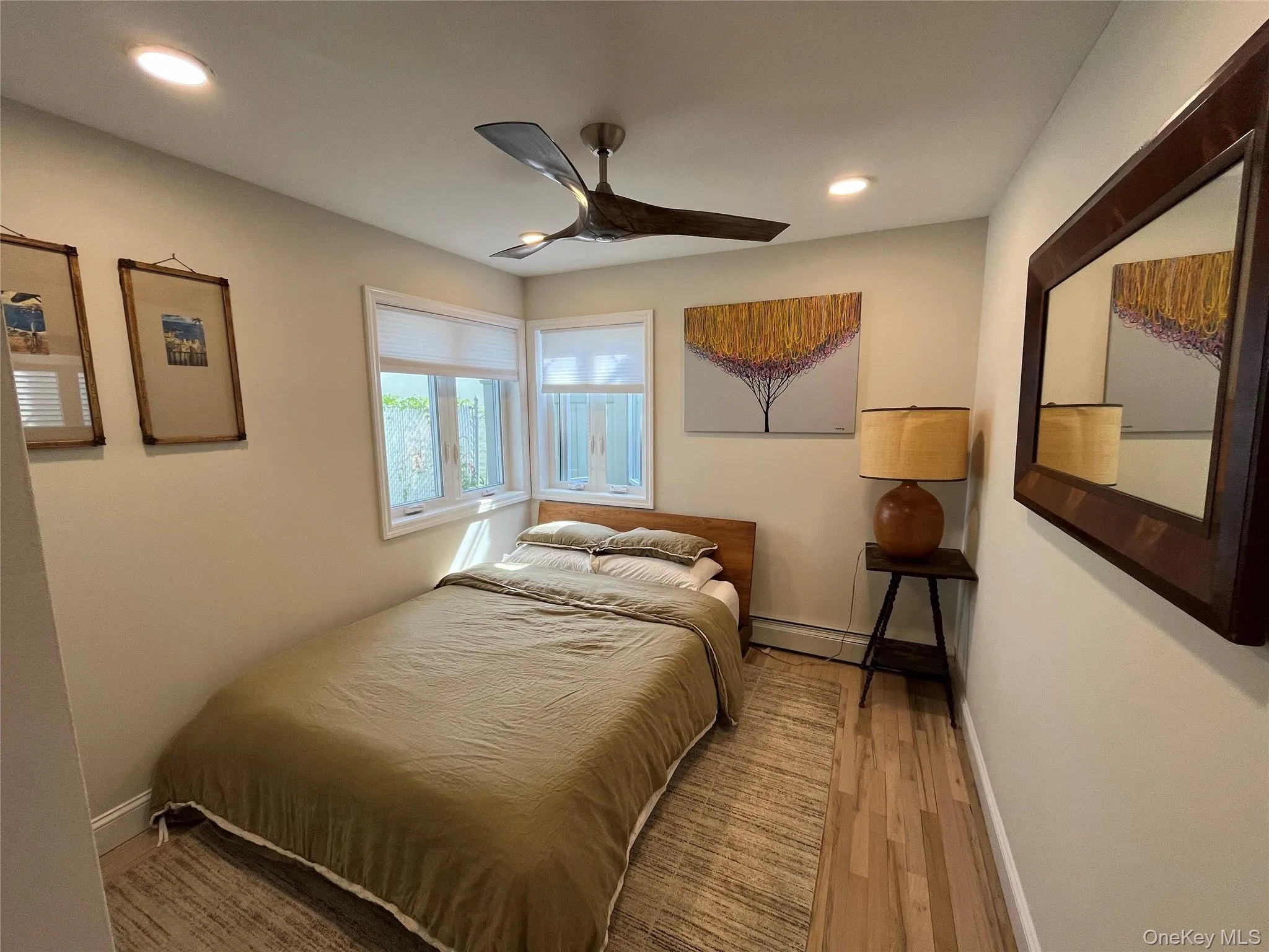 Bedroom with wood finished floors, a ceiling fan, and recessed lighting Bedroom with wood finished floors, a ceiling fan, and recessed lighting