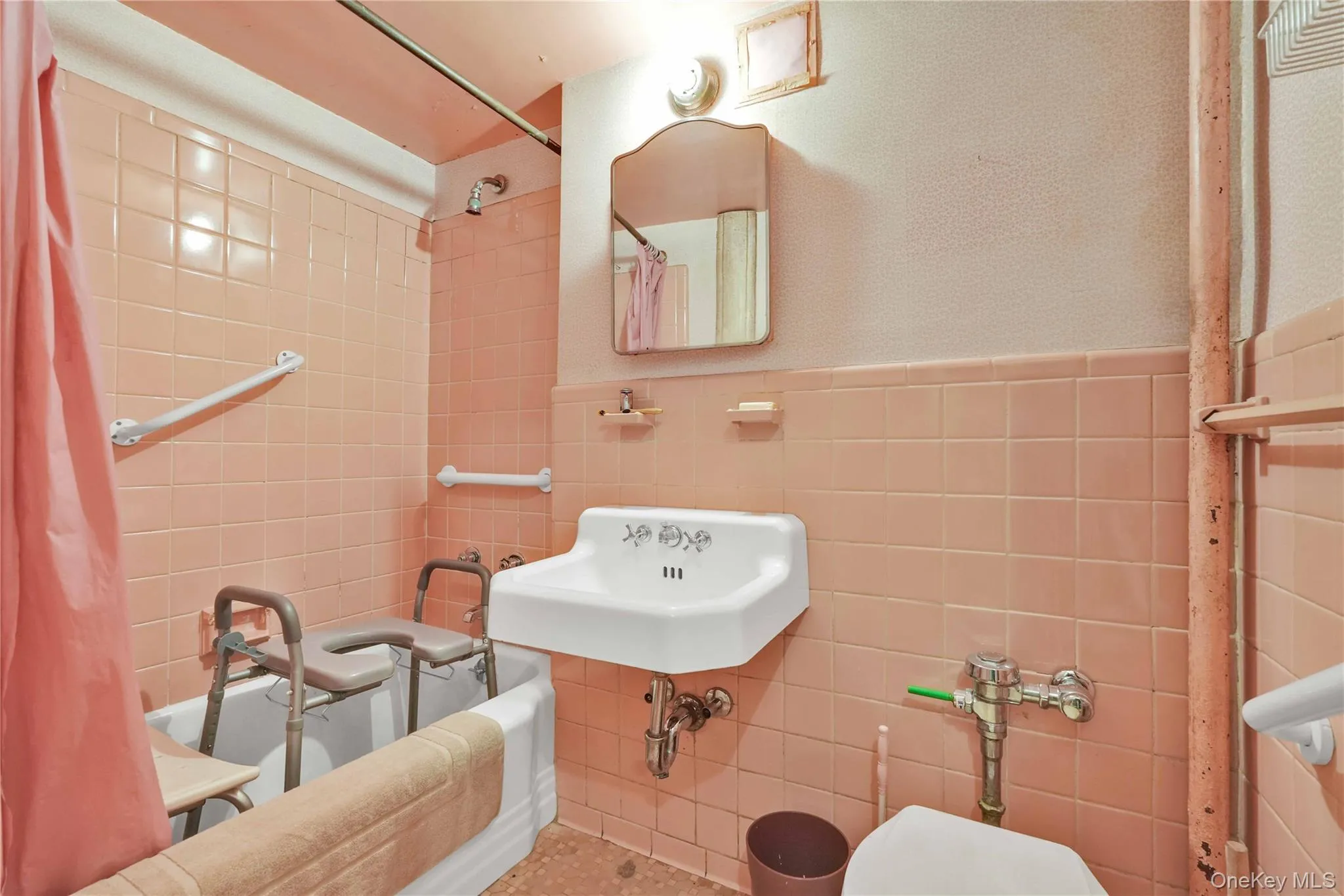 Bathroom with tile walls, tiled shower / bath combo, and wainscoting Bathroom with tile walls, tiled shower / bath combo, and wainscoting