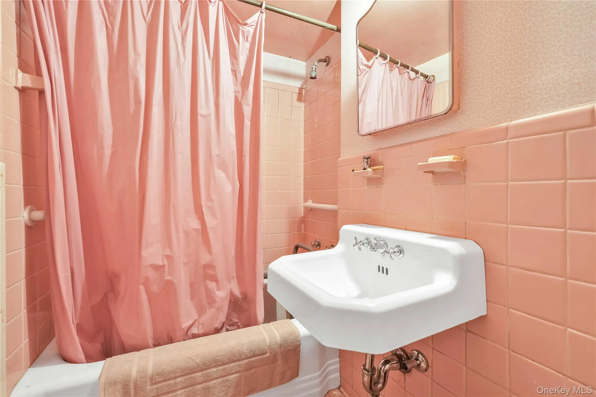 Bathroom featuring shower / bathtub combination with curtain and tile walls Bathroom featuring shower / bathtub combination with curtain and tile walls