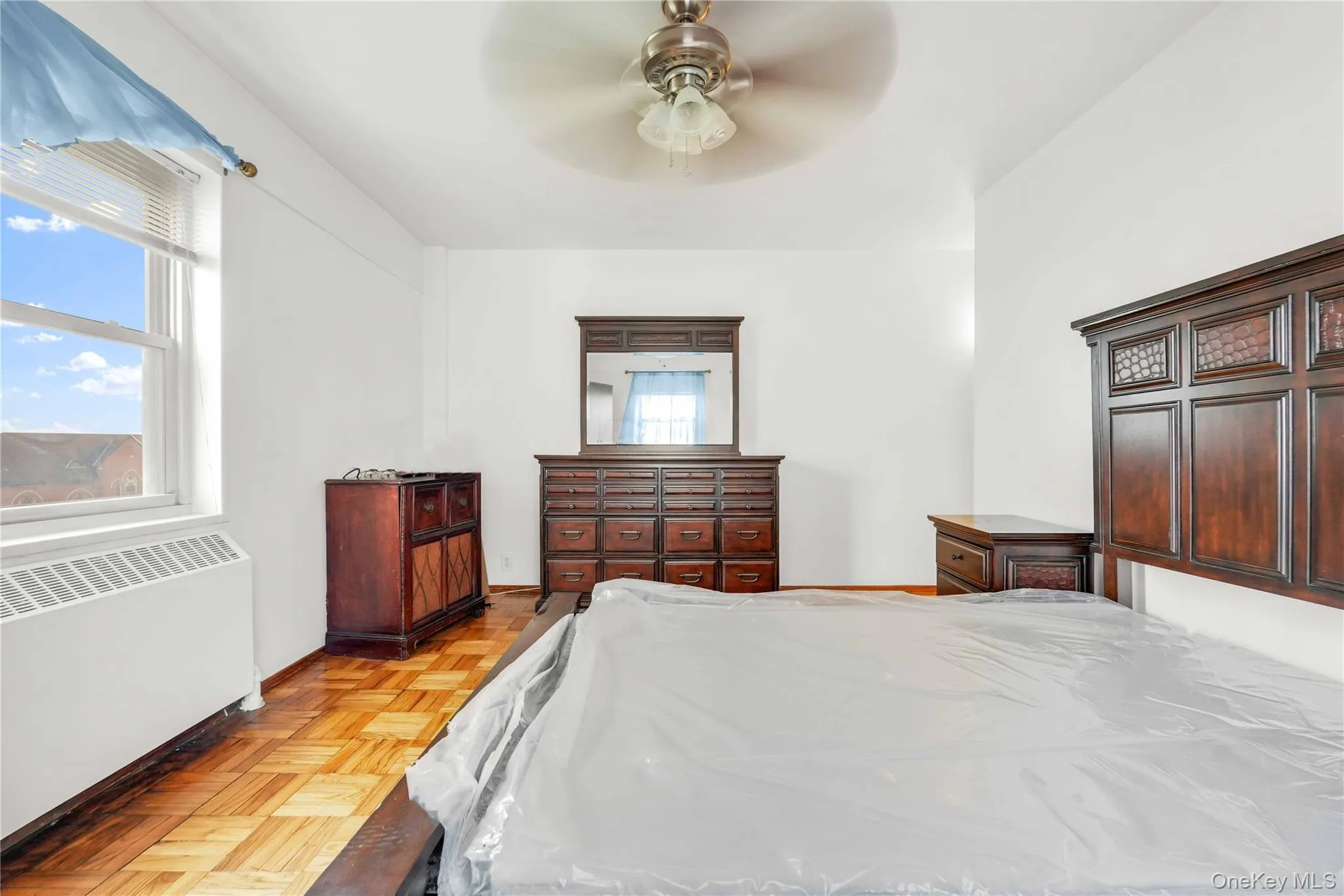 Bedroom with radiator and ceiling fan Bedroom with radiator and ceiling fan