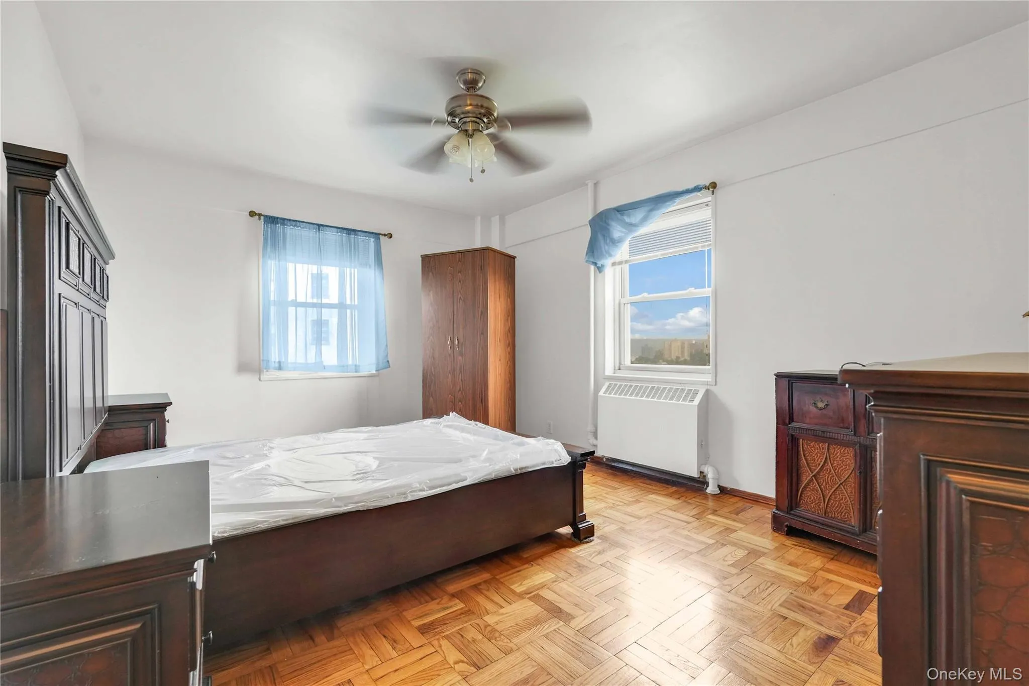 Bedroom with radiator and ceiling fan Bedroom with radiator and ceiling fan