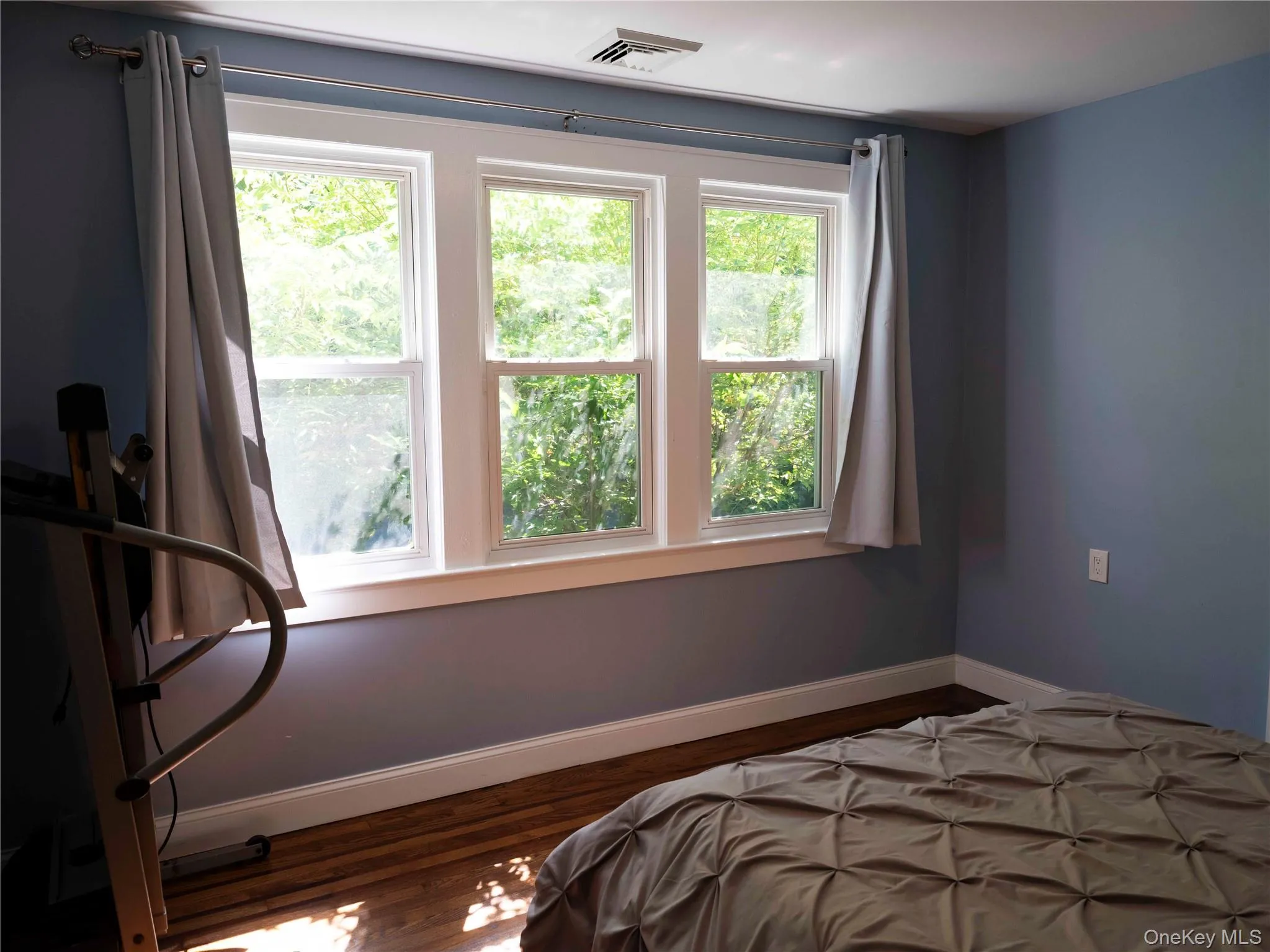 Bedroom with baseboards and wood finished floors Bedroom with baseboards and wood finished floors