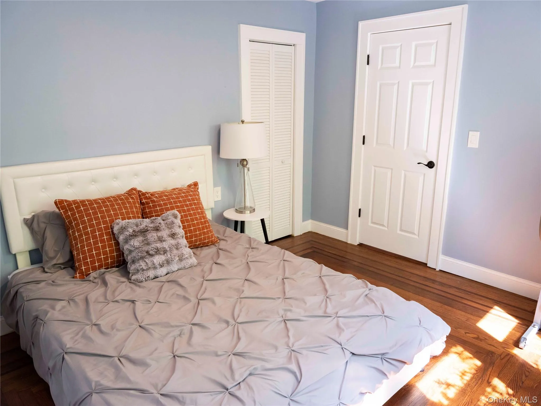 Bedroom with dark wood-style flooring and a closet Bedroom with dark wood-style flooring and a closet