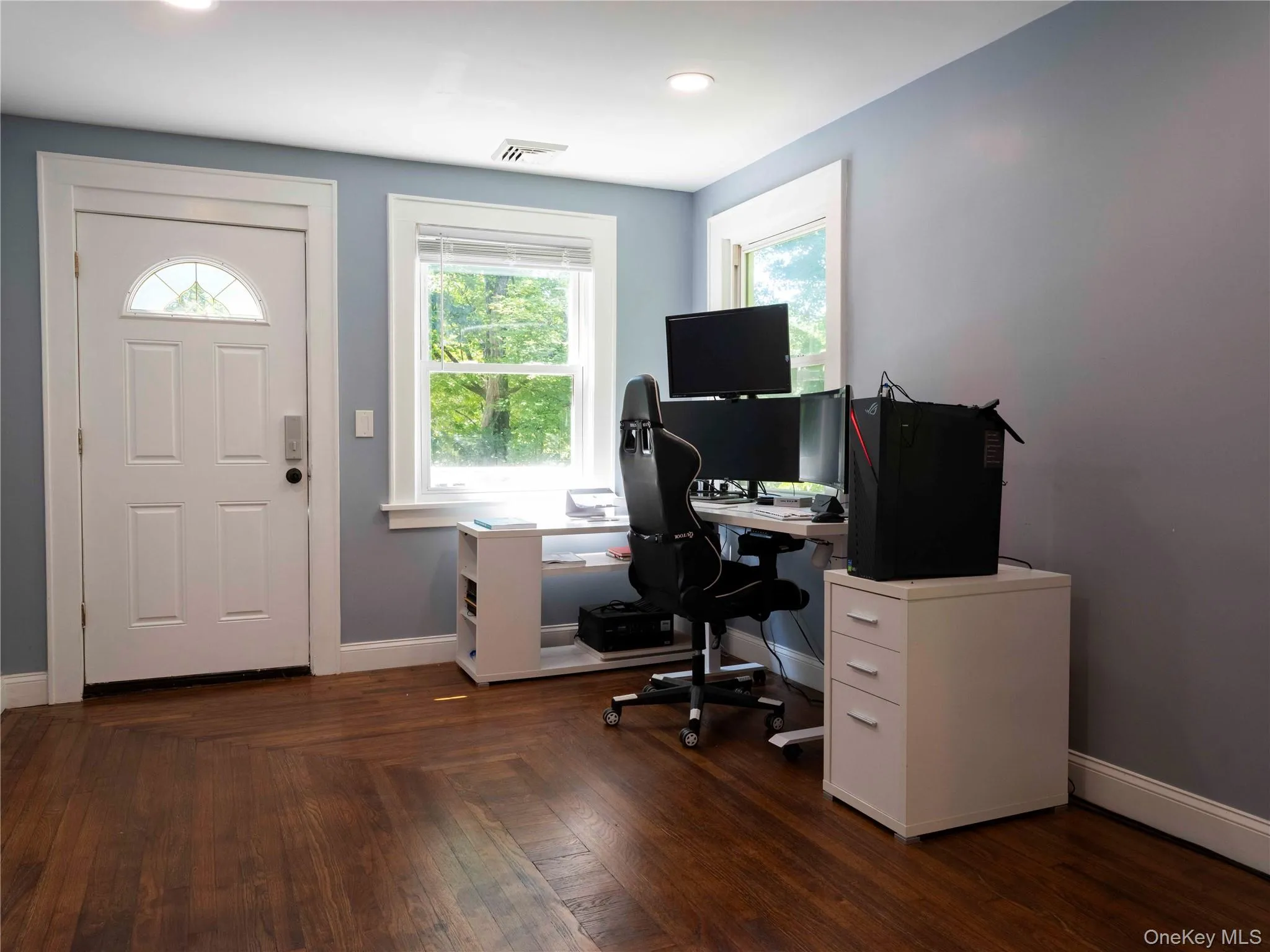 Office area with baseboards and dark wood-style flooring Office area with baseboards and dark wood-style flooring