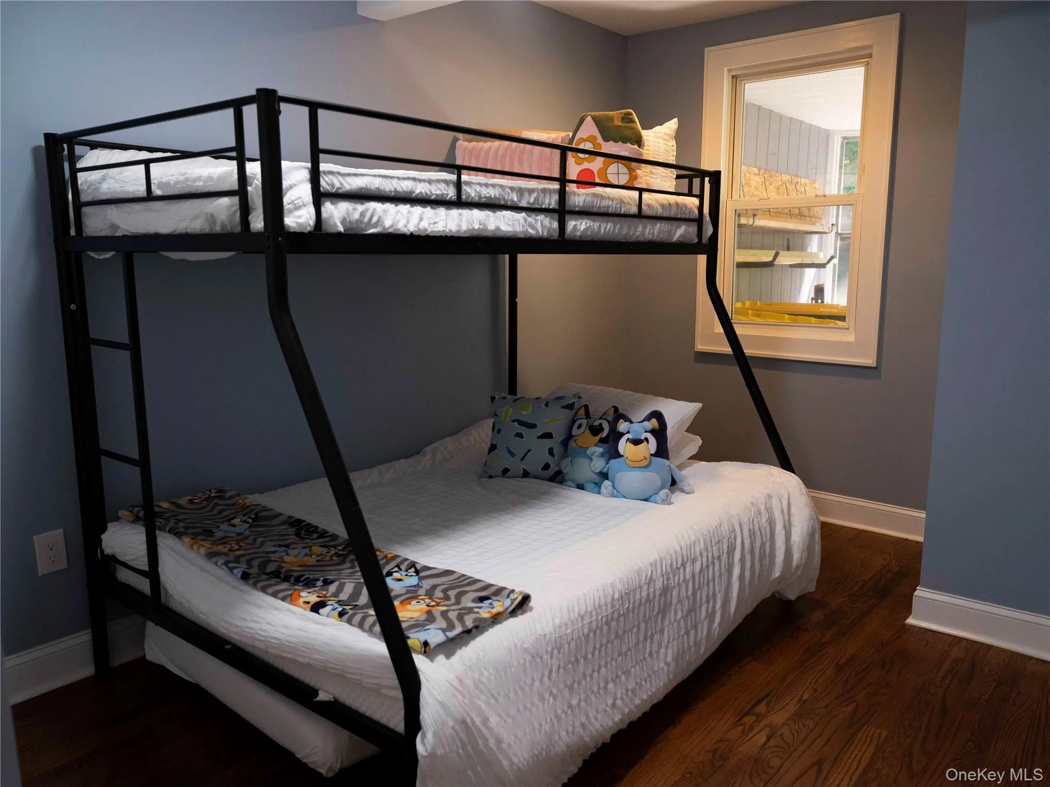 Bedroom featuring baseboards and dark wood-type flooring Bedroom featuring baseboards and dark wood-type flooring