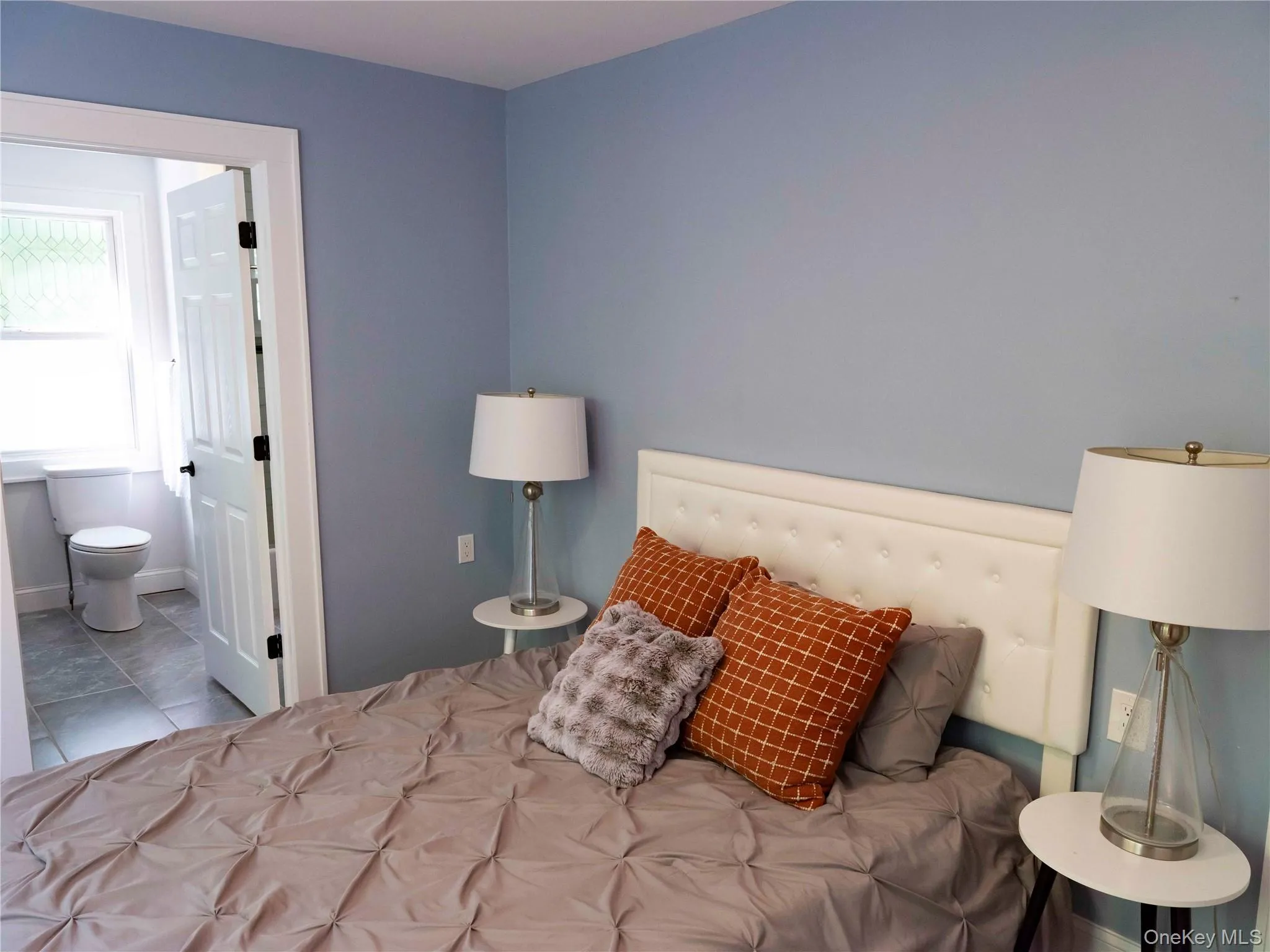 Tiled bedroom featuring ensuite bathroom Tiled bedroom featuring ensuite bathroom