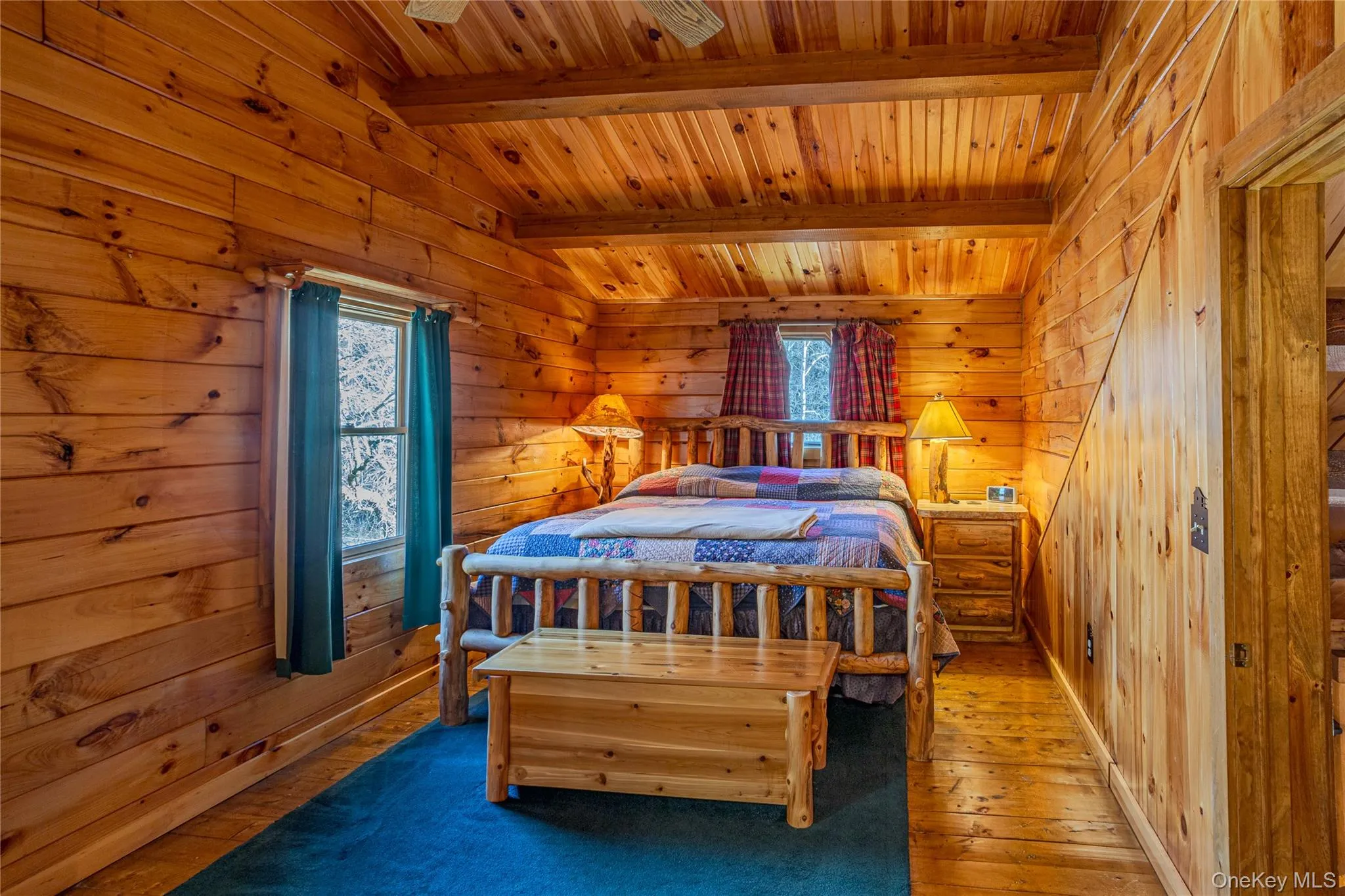 Bedroom featuring wood-type flooring, wooden ceiling, wood walls, and a relaxing sauna Bedroom featuring wood-type flooring, wooden ceiling, wood walls, and a relaxing sauna
