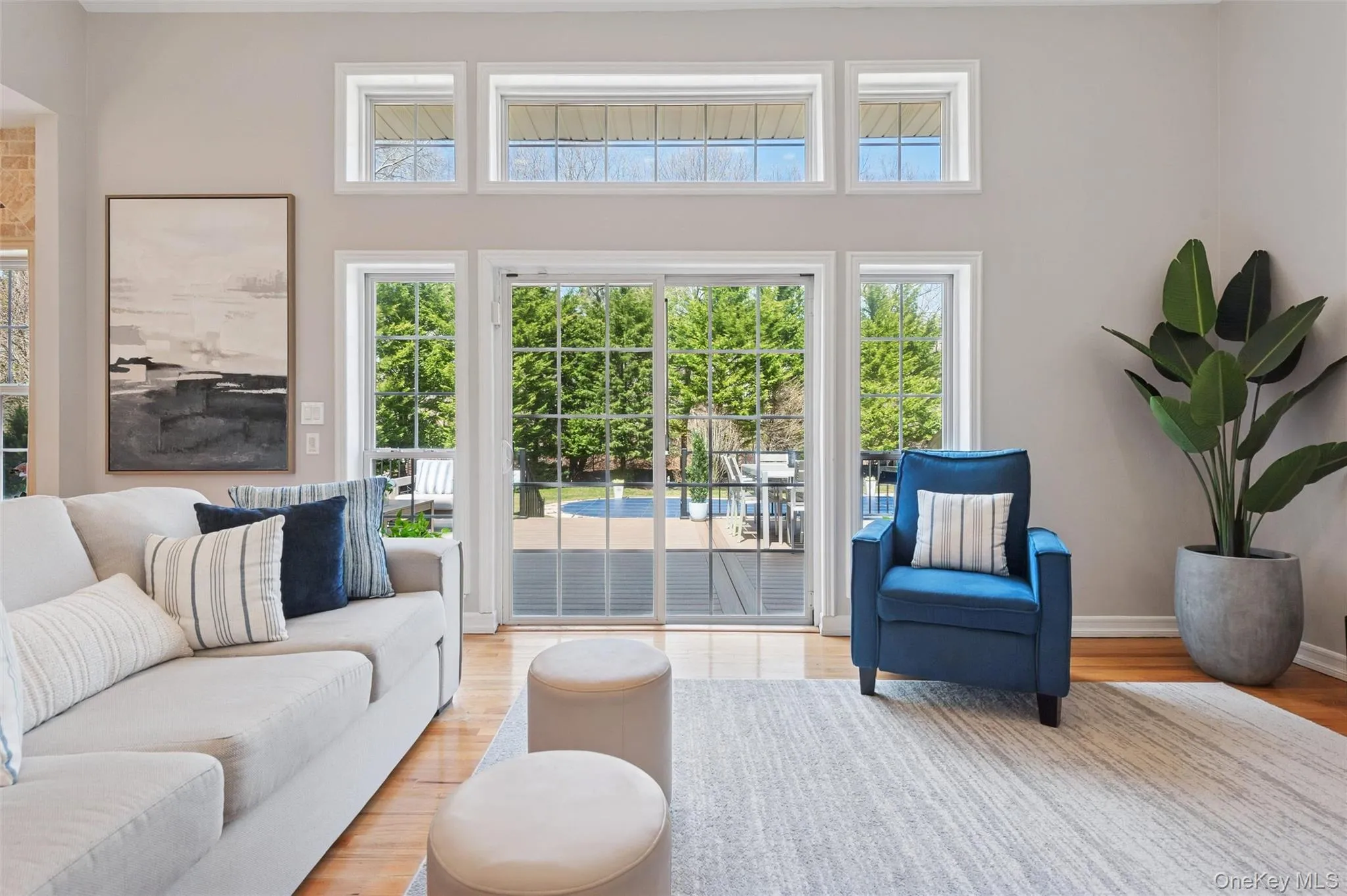 Living area with light wood-style flooring and baseboards Living area with light wood-style flooring and baseboards