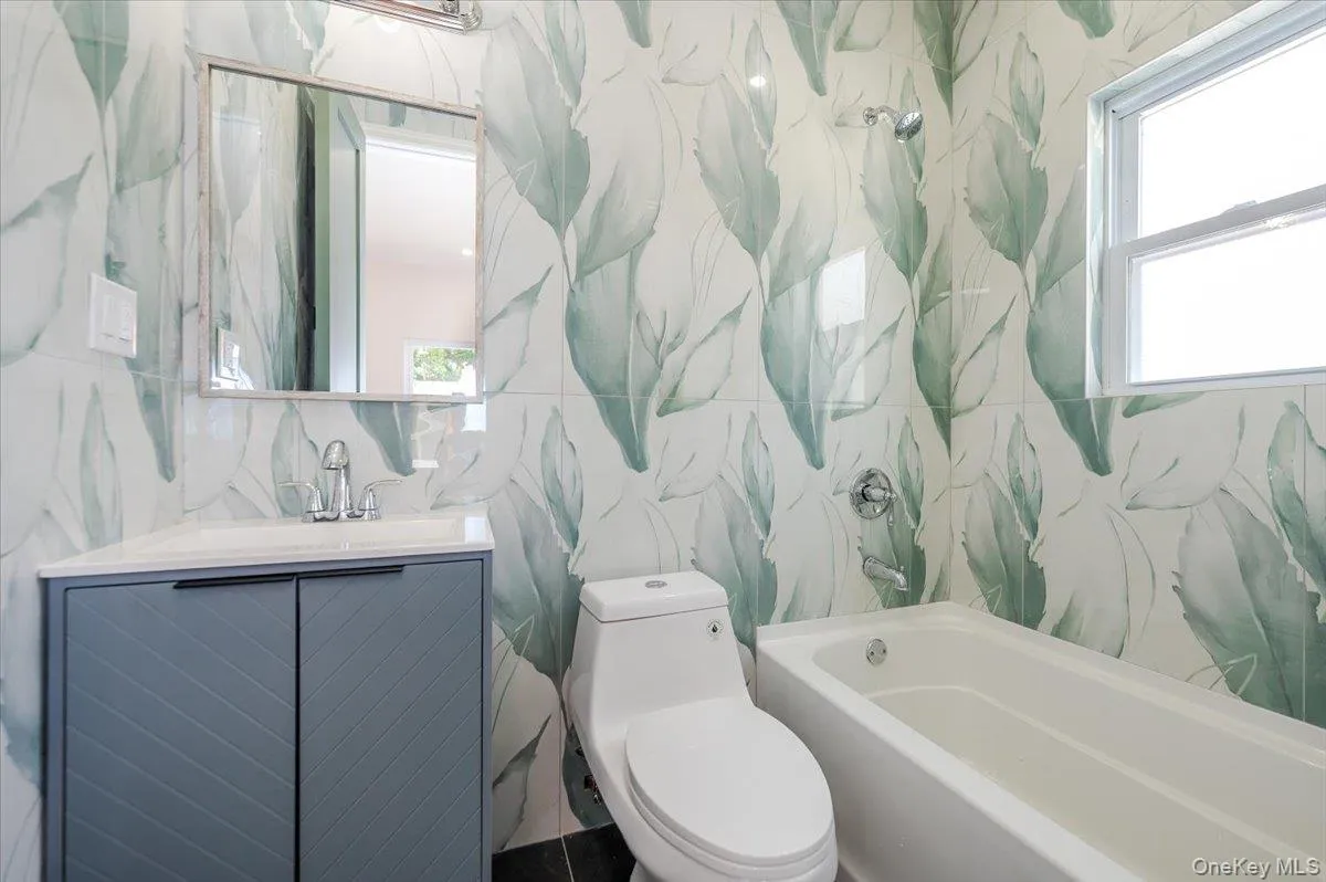 Full bathroom with vanity and plenty of natural light Full bathroom with vanity and plenty of natural light