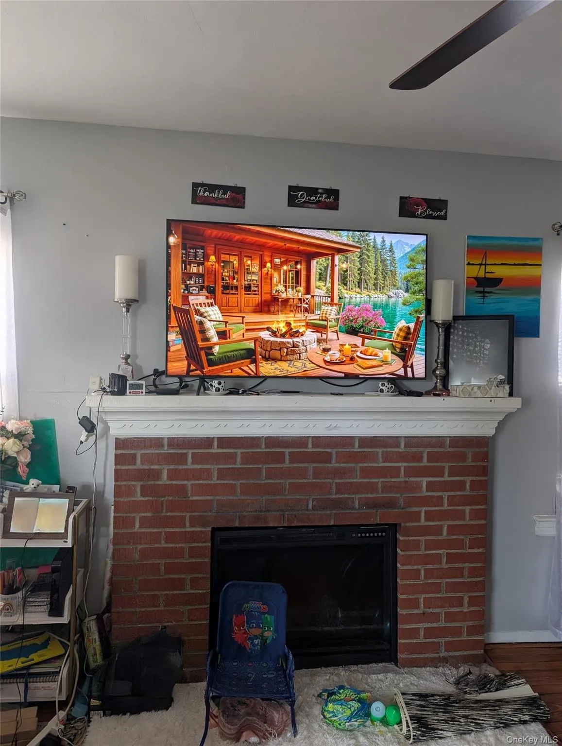 Detailed view of a fireplace and wood finished flooring Detailed view of a fireplace and wood finished flooring