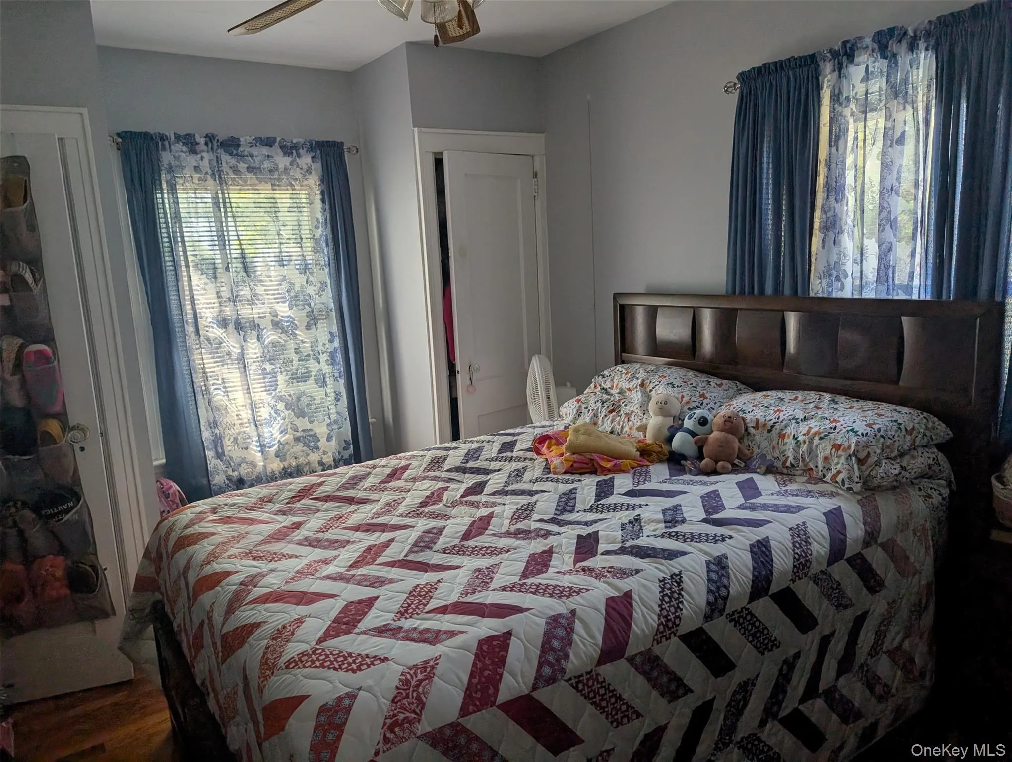 Bedroom featuring dark wood-style floors and a ceiling fan Bedroom featuring dark wood-style floors and a ceiling fan