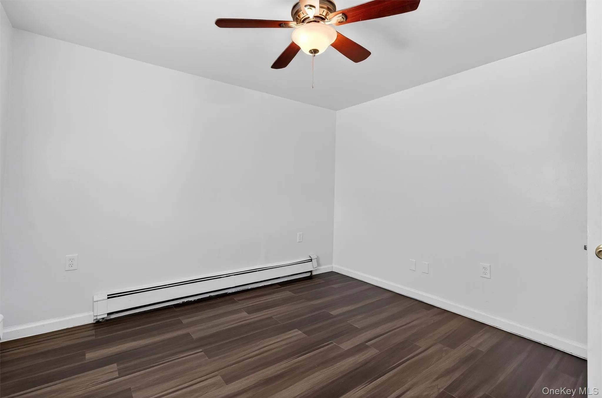 Bright bedroom with newer floors and ceiling fan Bright bedroom with newer floors and ceiling fan