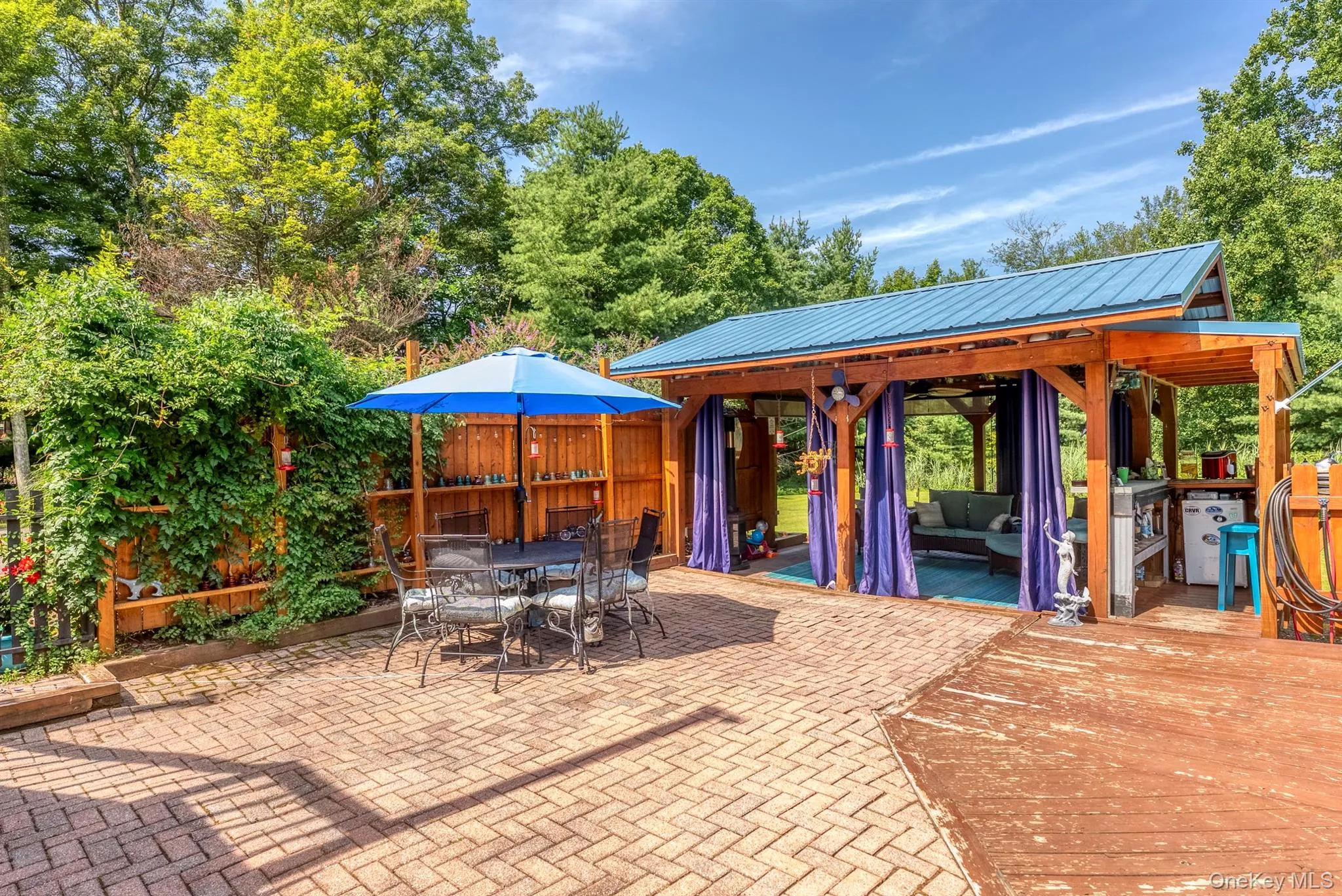 View of patio with outdoor dining space and a gazebo View of patio with outdoor dining space and a gazebo