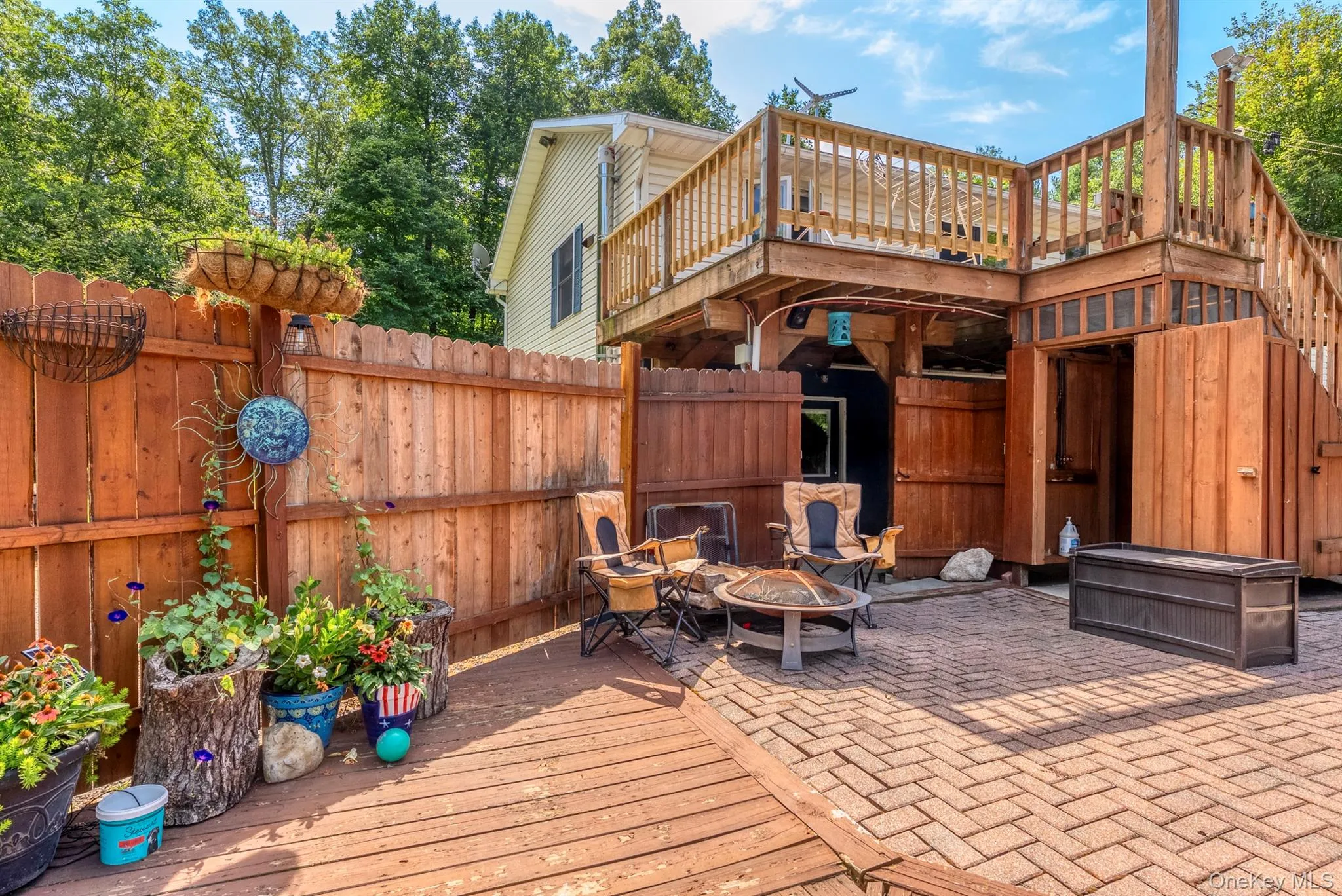 View of patio with a deck and a fire pit View of patio with a deck and a fire pit