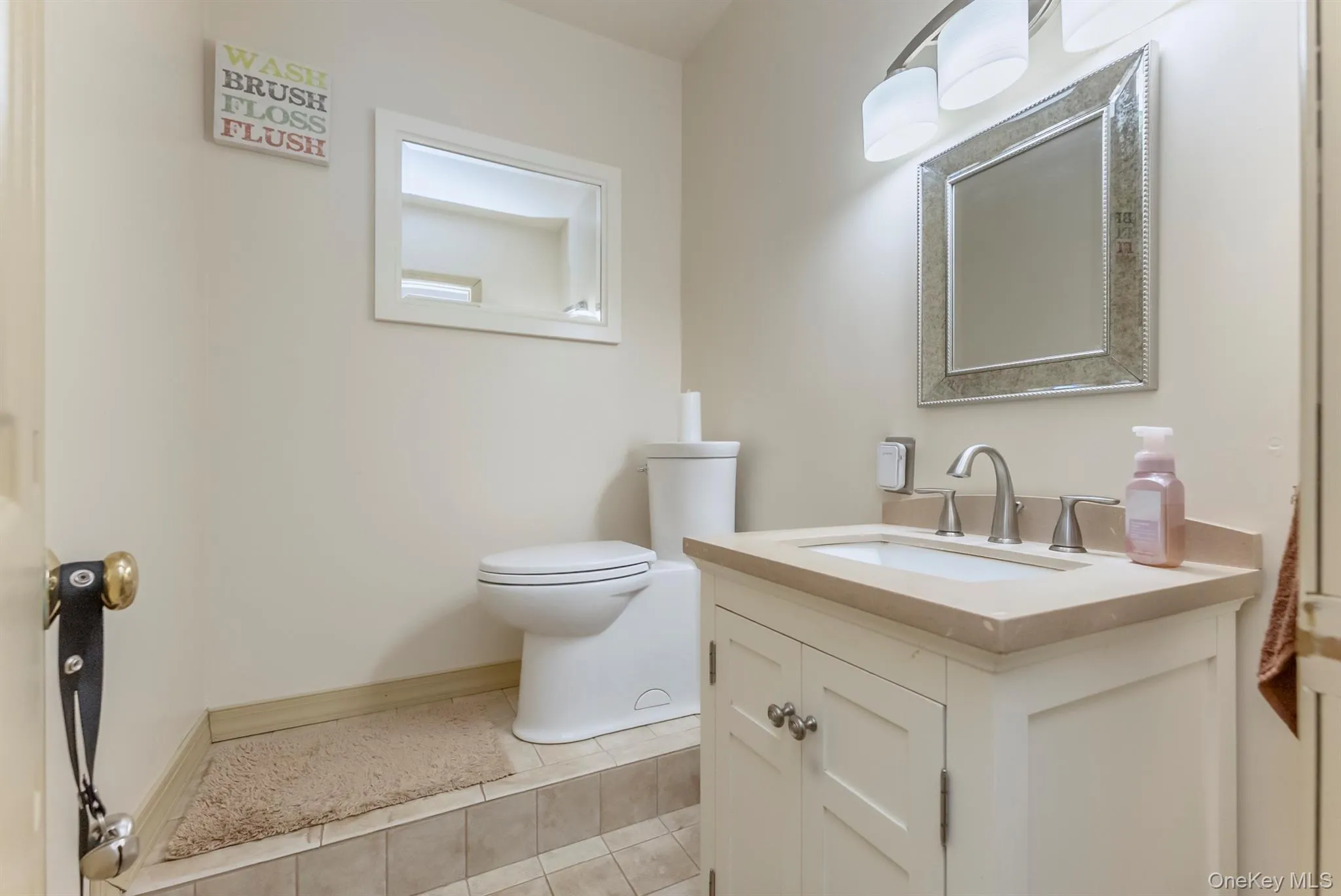 Bathroom with vanity and light tile patterned floors Bathroom with vanity and light tile patterned floors