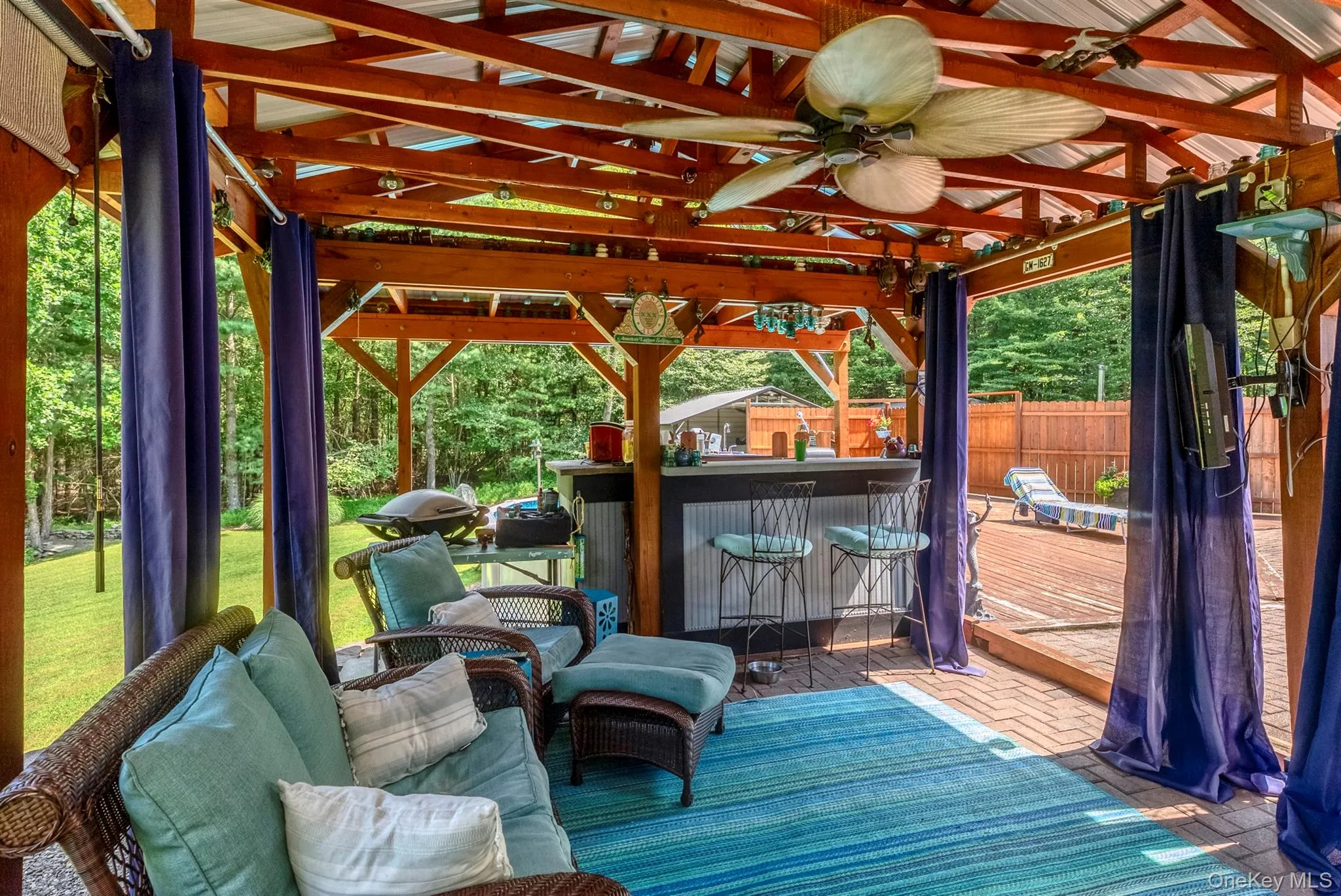 Wooden terrace featuring ceiling fan Wooden terrace featuring ceiling fan