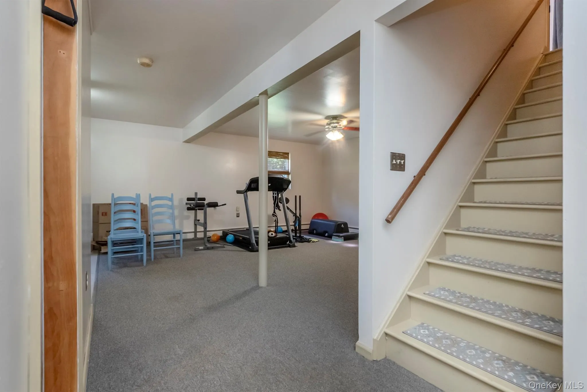 Workout area featuring carpet floors and a ceiling fan Workout area featuring carpet floors and a ceiling fan