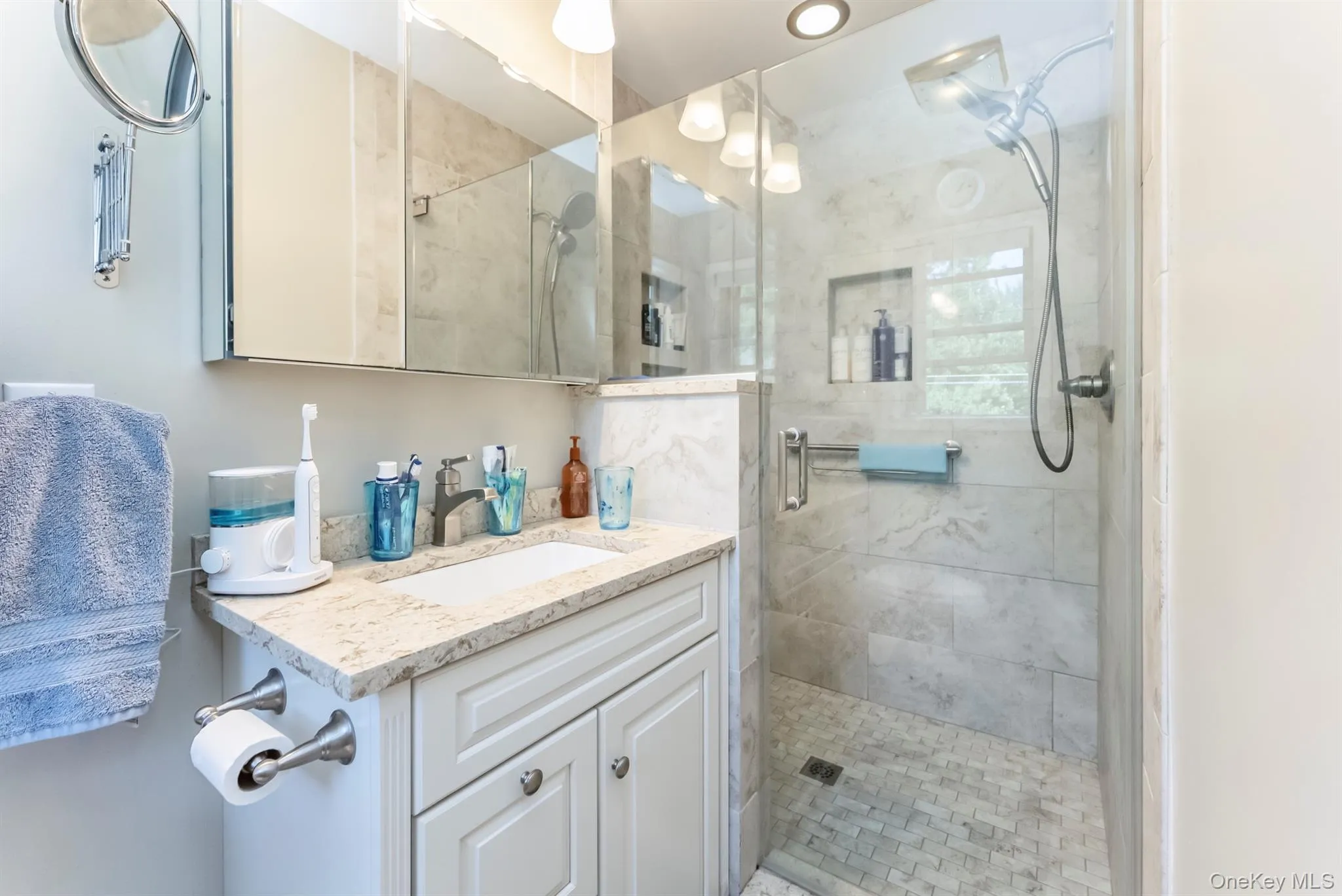 Full bathroom featuring a stall shower and vanity Full bathroom featuring a stall shower and vanity
