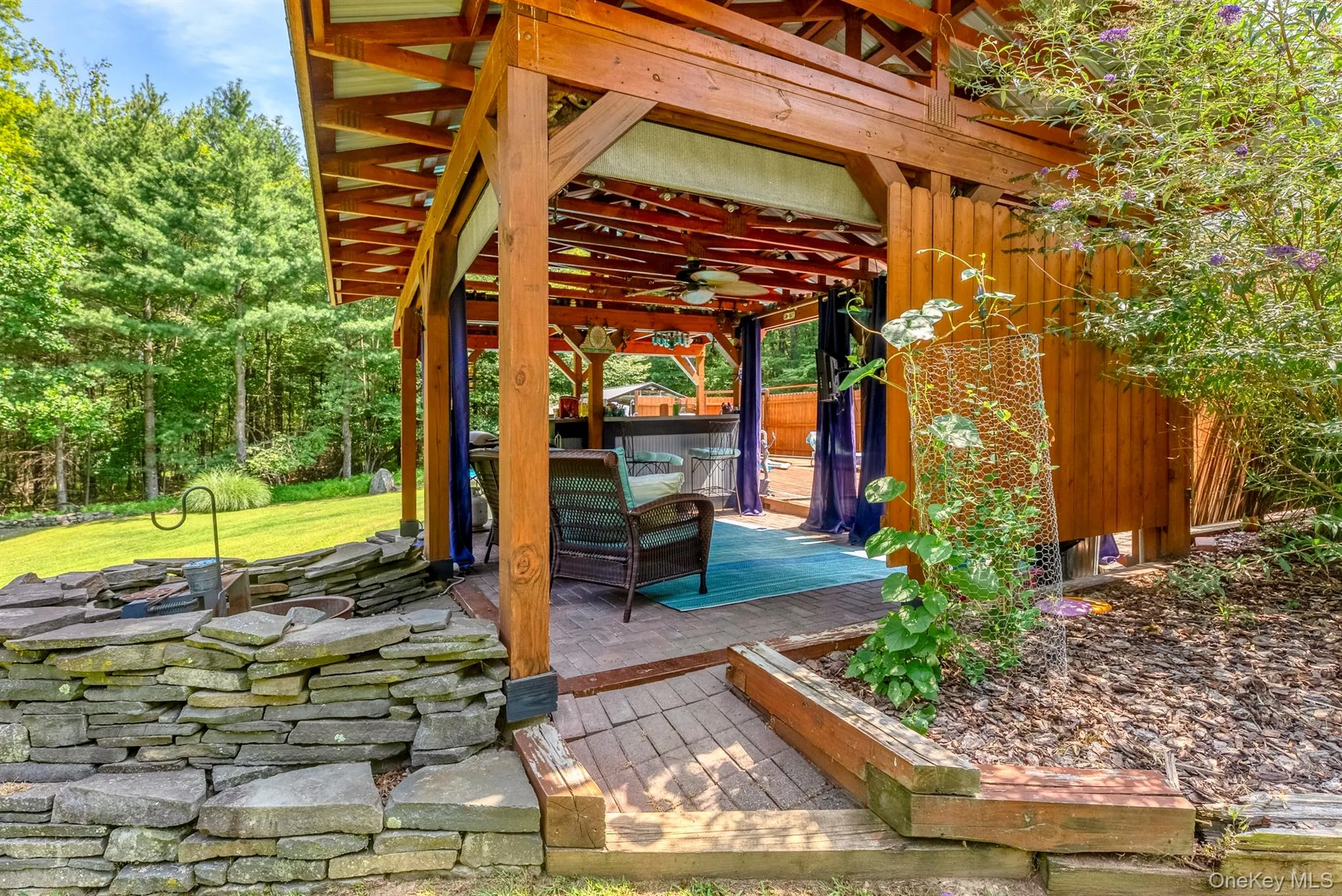 View of patio featuring a wooden deck and a ceiling fan View of patio featuring a wooden deck and a ceiling fan