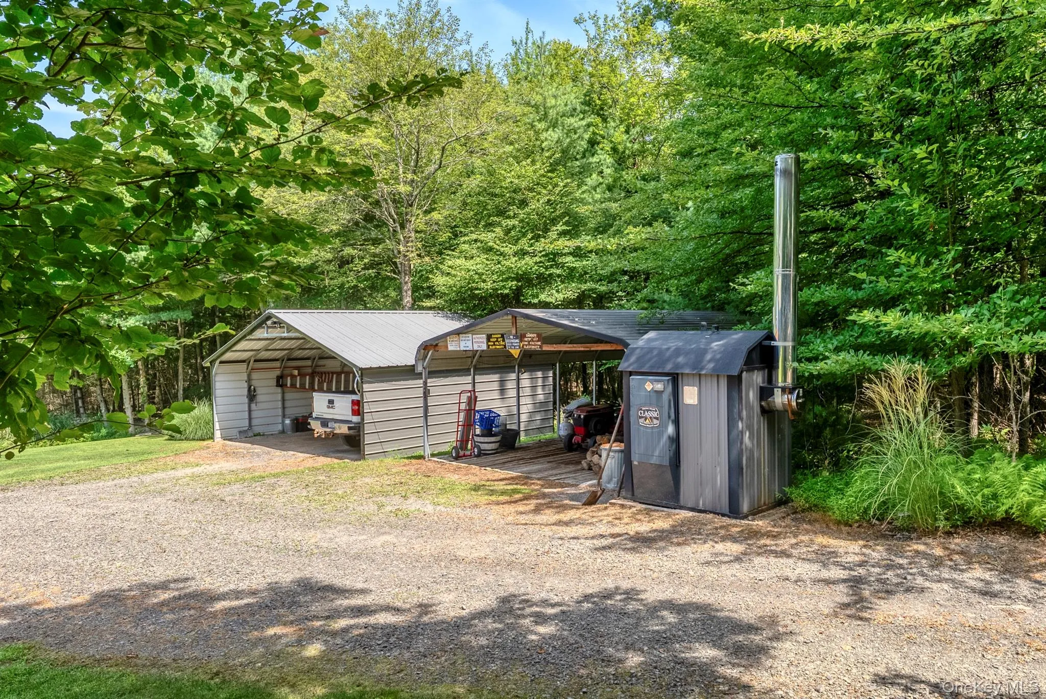 View of shed with gravel driveway and a detached carport View of shed with gravel driveway and a detached carport