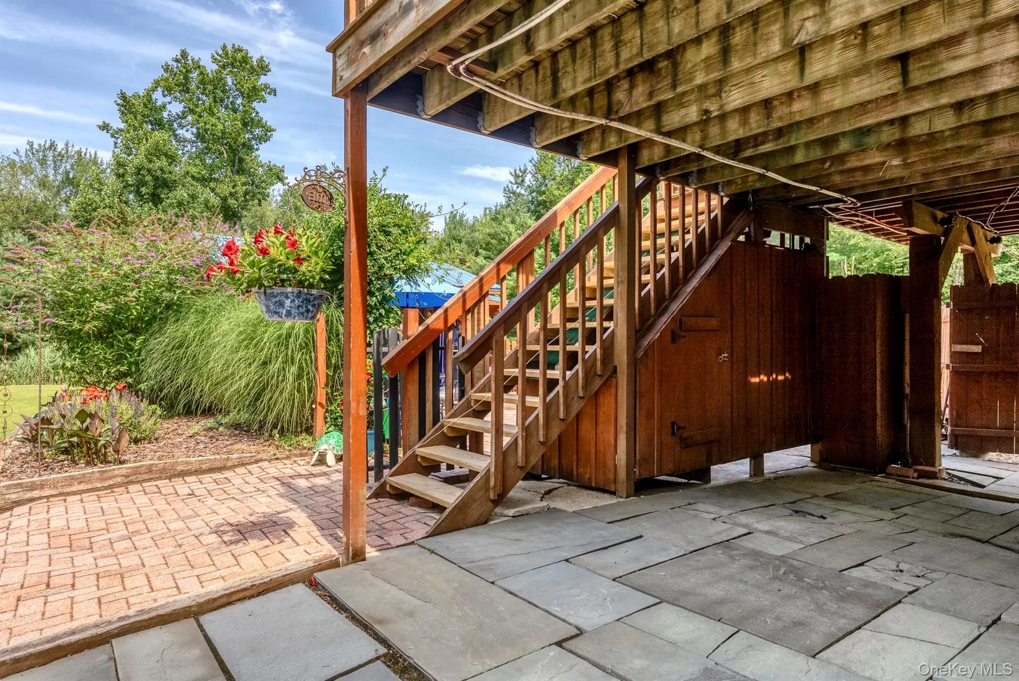 View of patio featuring stairway and a wooden deck View of patio featuring stairway and a wooden deck