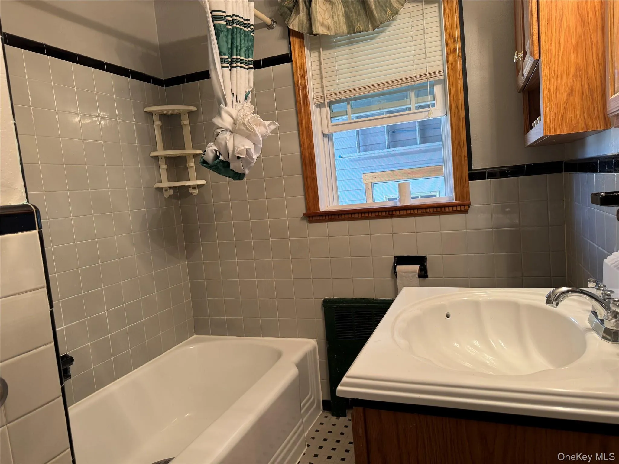 Full bathroom featuring vanity and tile walls Full bathroom featuring vanity and tile walls